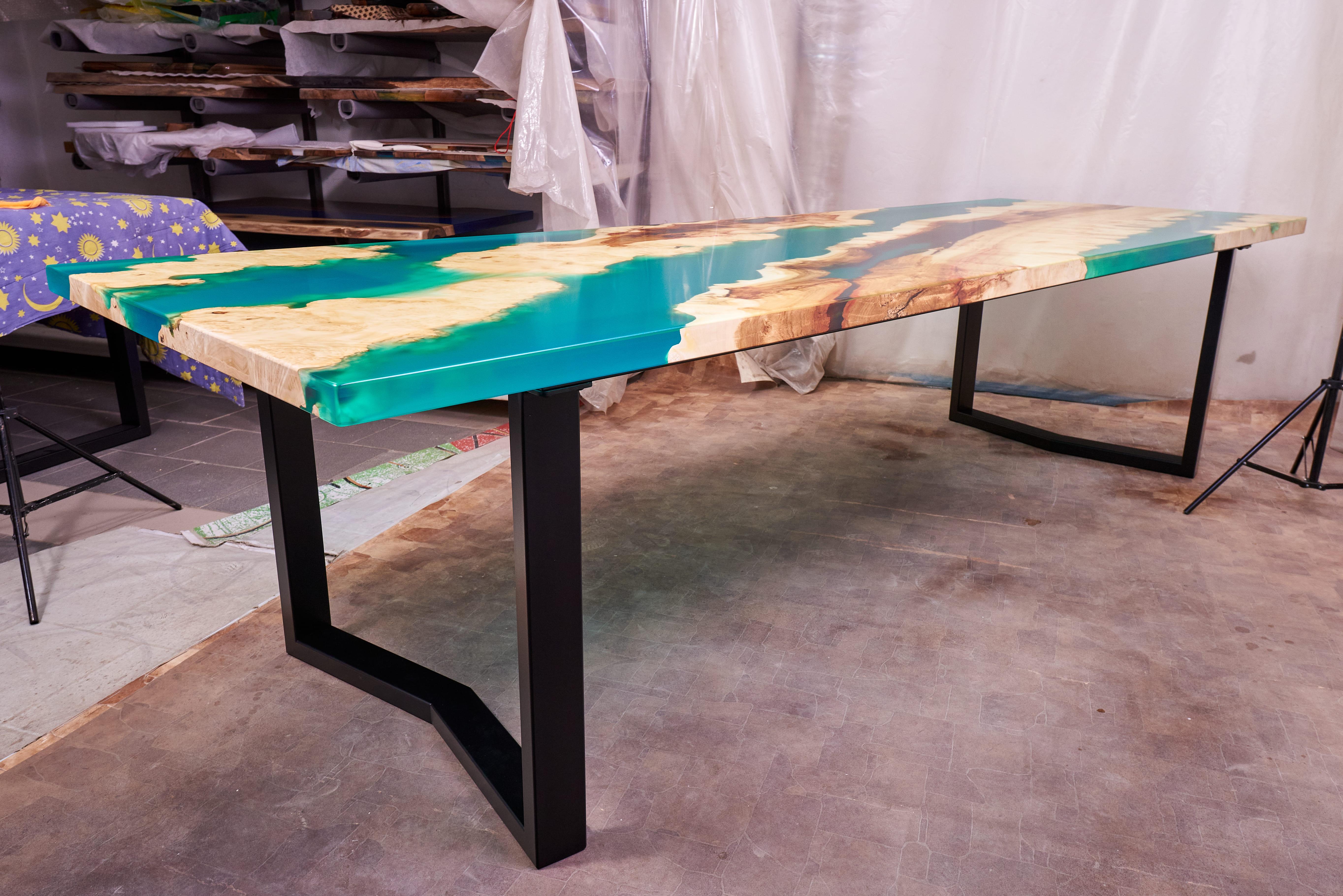 Introducing the awe-inspiring Ancient Maple Burl Large Dining Table with Emerald Resin—a truly one-of-a-kind masterpiece crafted by the hands of great artists. This magnificent table brings together the timeless beauty of ancient maple burl wood and