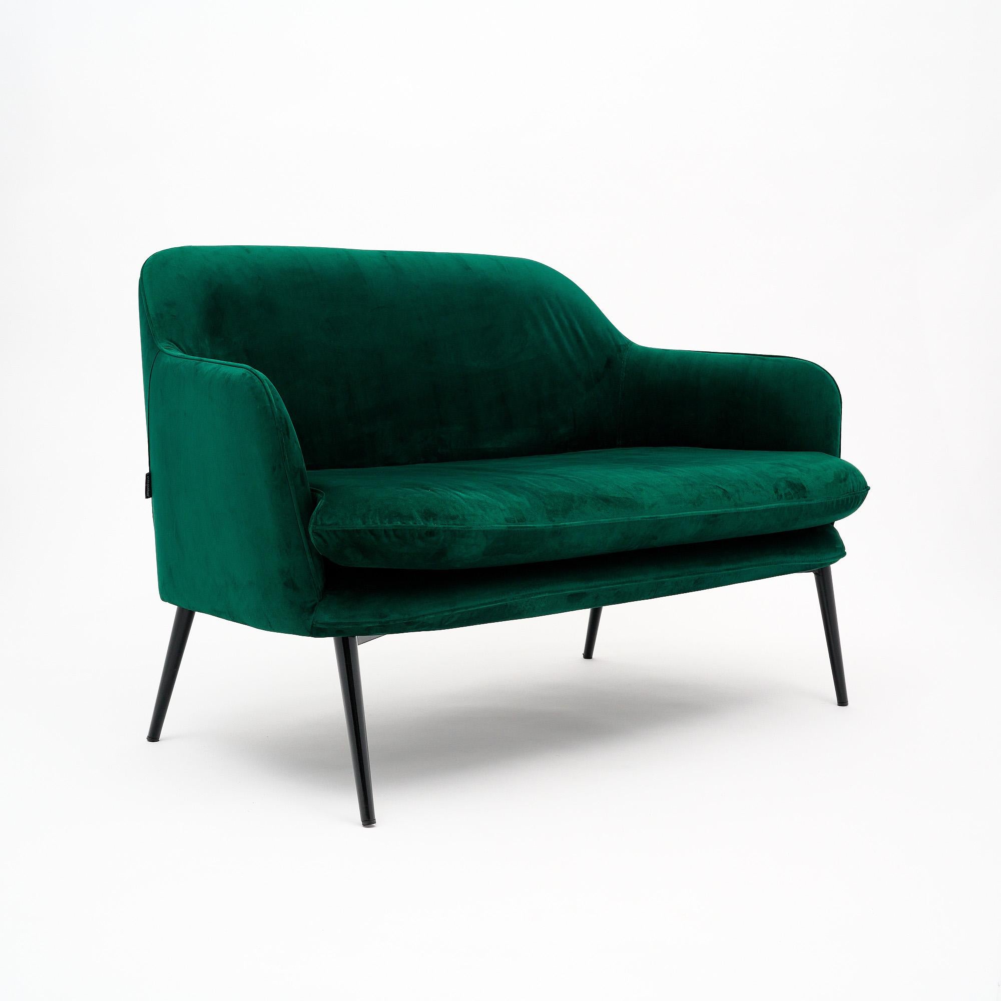 Settee or small sofa by PolsPotten completely upholstered in a lush emerald green velvet. The piece has four ebonized, tapered legs. This piece is in very nice condition with only minor surface wear consistent with age and use. The photos accurately