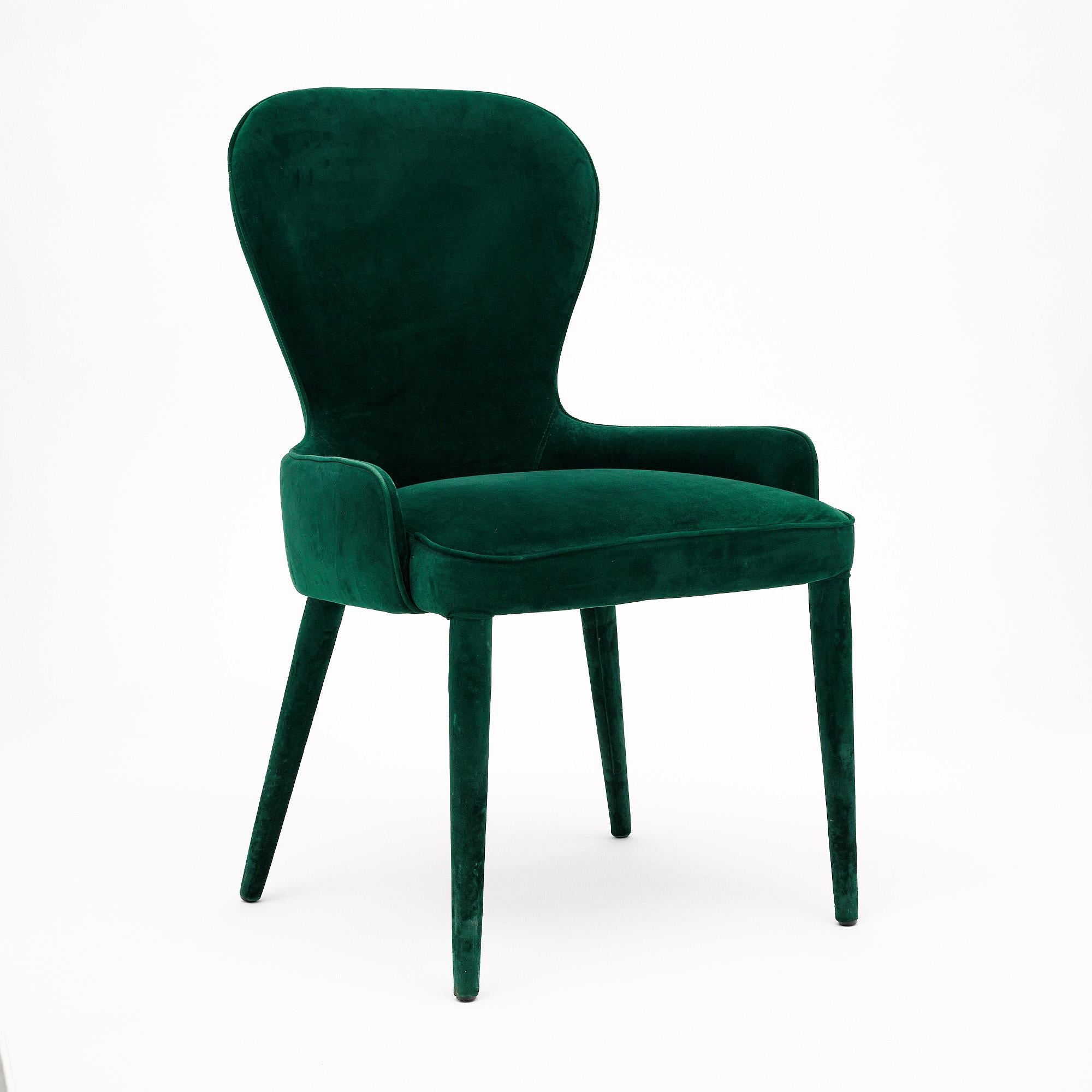 Single side chair from France completely upholstered in a lush emerald colored green velvet. The four tapered legs are also covered in the green velvet. This piece is in very nice vintage condition with only minor surface wear consistent with age