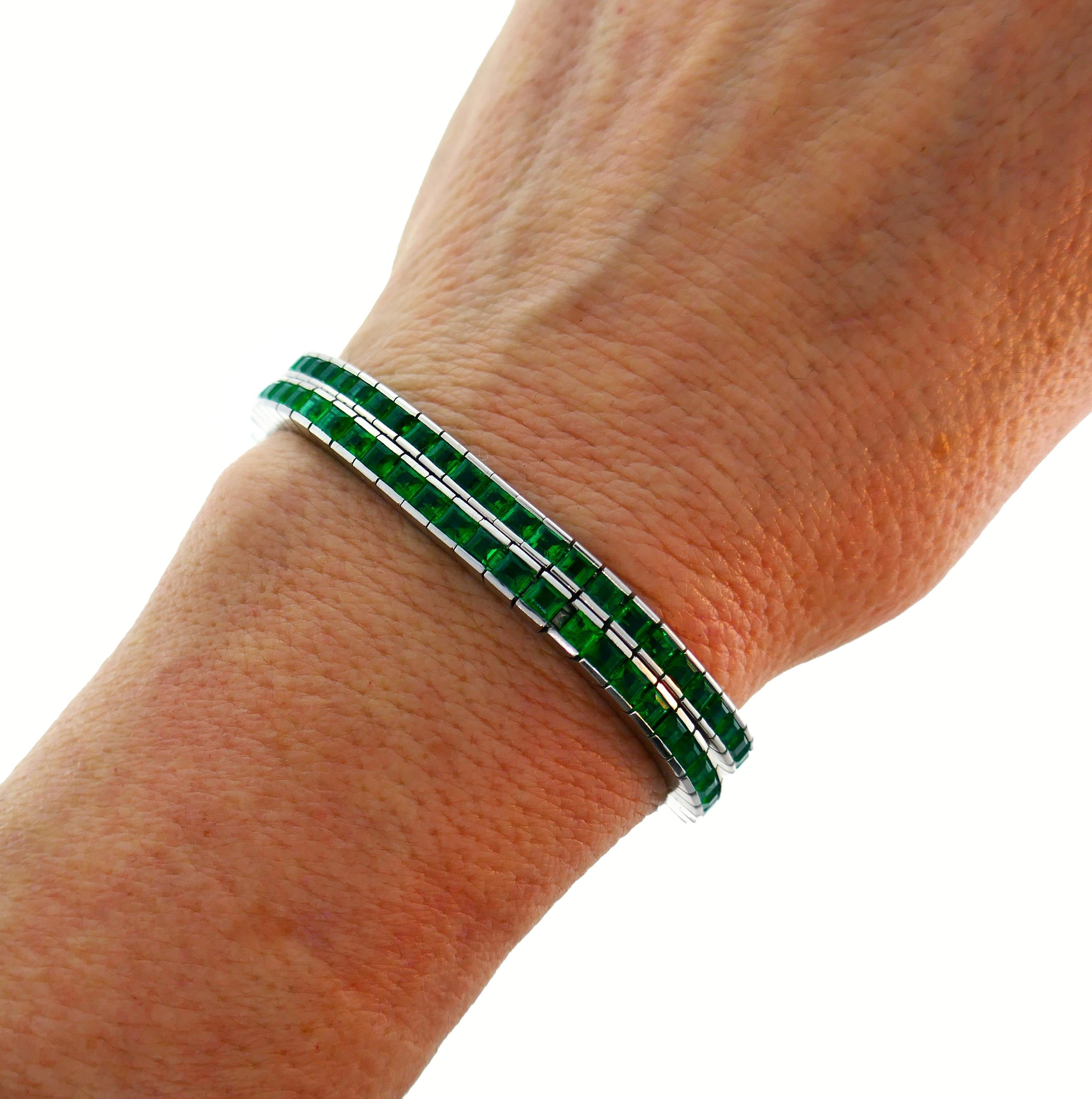 A pair of stunning ideally matched emerald and 18 karat white gold tennis bracelets. Each bracelet is substantial on its own and great for piling up.
Once bracelet is made by Meister and features fifty-nine table cut emeralds approximately 0.15
