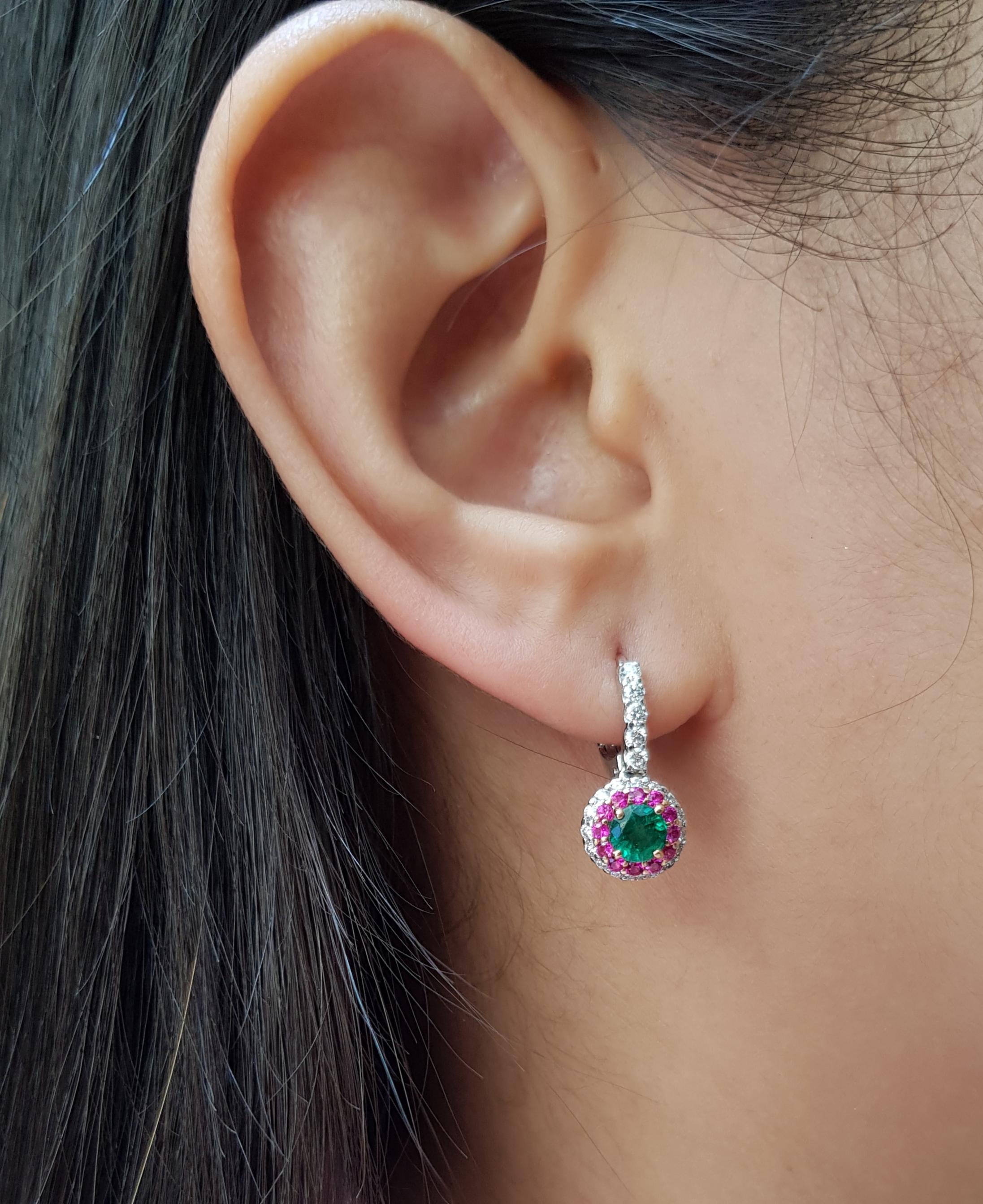 Emerald 0.91 carat with Diamond 0.53 carat and Pink Sapphire 0.38 carat Earrings set in 18 Karat White Gold Settings

Width: 0.9 cm
Length: 2.2 cm 

