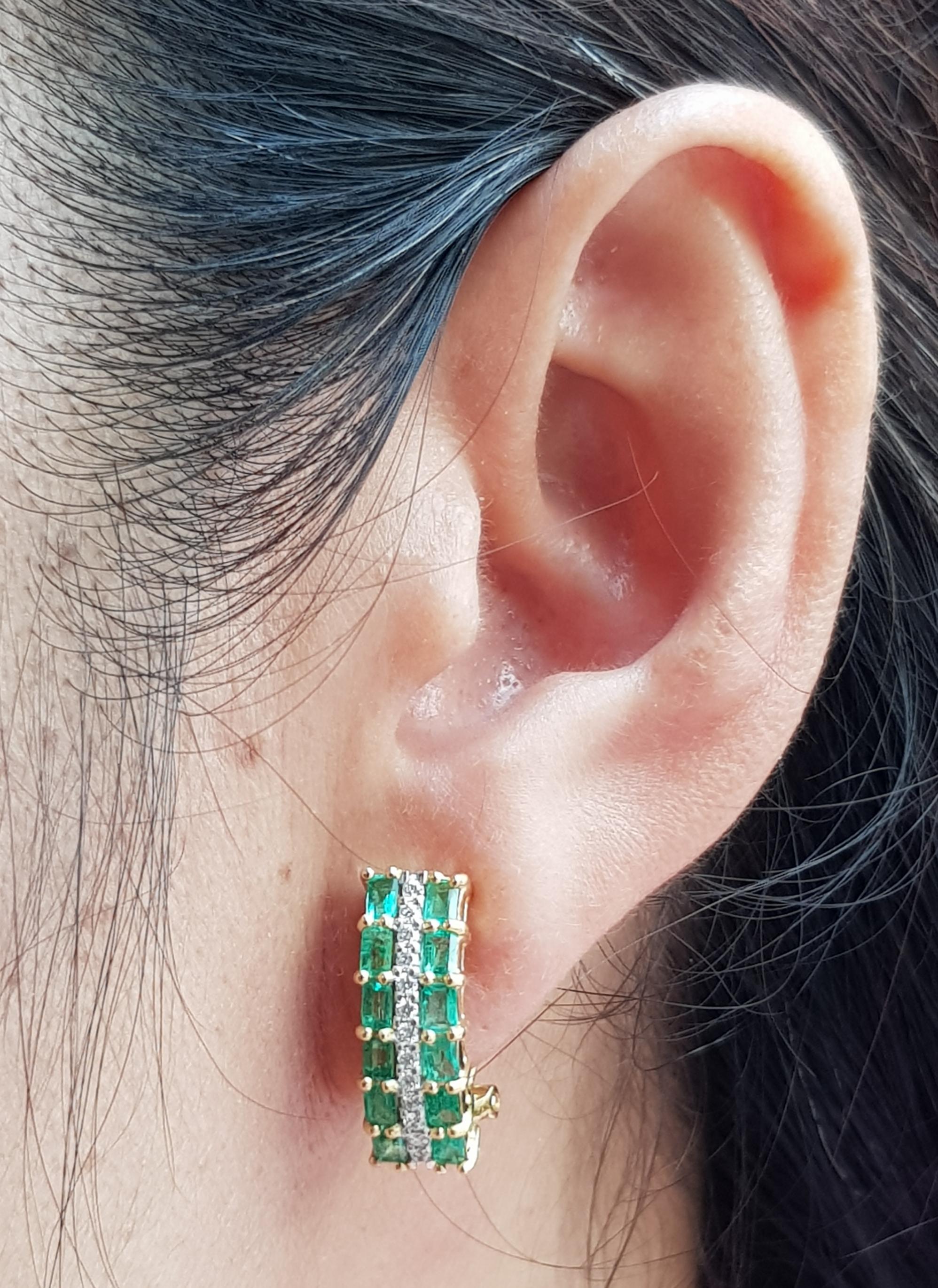 Emerald 1.66 carats with Diamond 0.24 carat Earrings set in 18 Karat Gold Settings

Width:  0.6 cm 
Length: 1.8 cm
Total Weight: 9.36 grams

