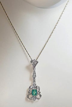 Emerald with Diamond Pendant set in 14K White Gold Setting