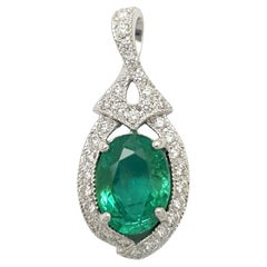 Emerald with Diamond Pendant set in 18K White Gold Settings