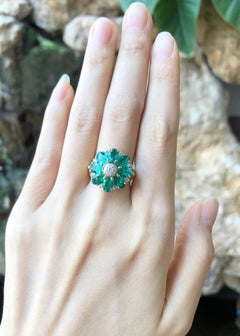 Emerald with Diamond Ring Set in 18 Karat Gold Settings