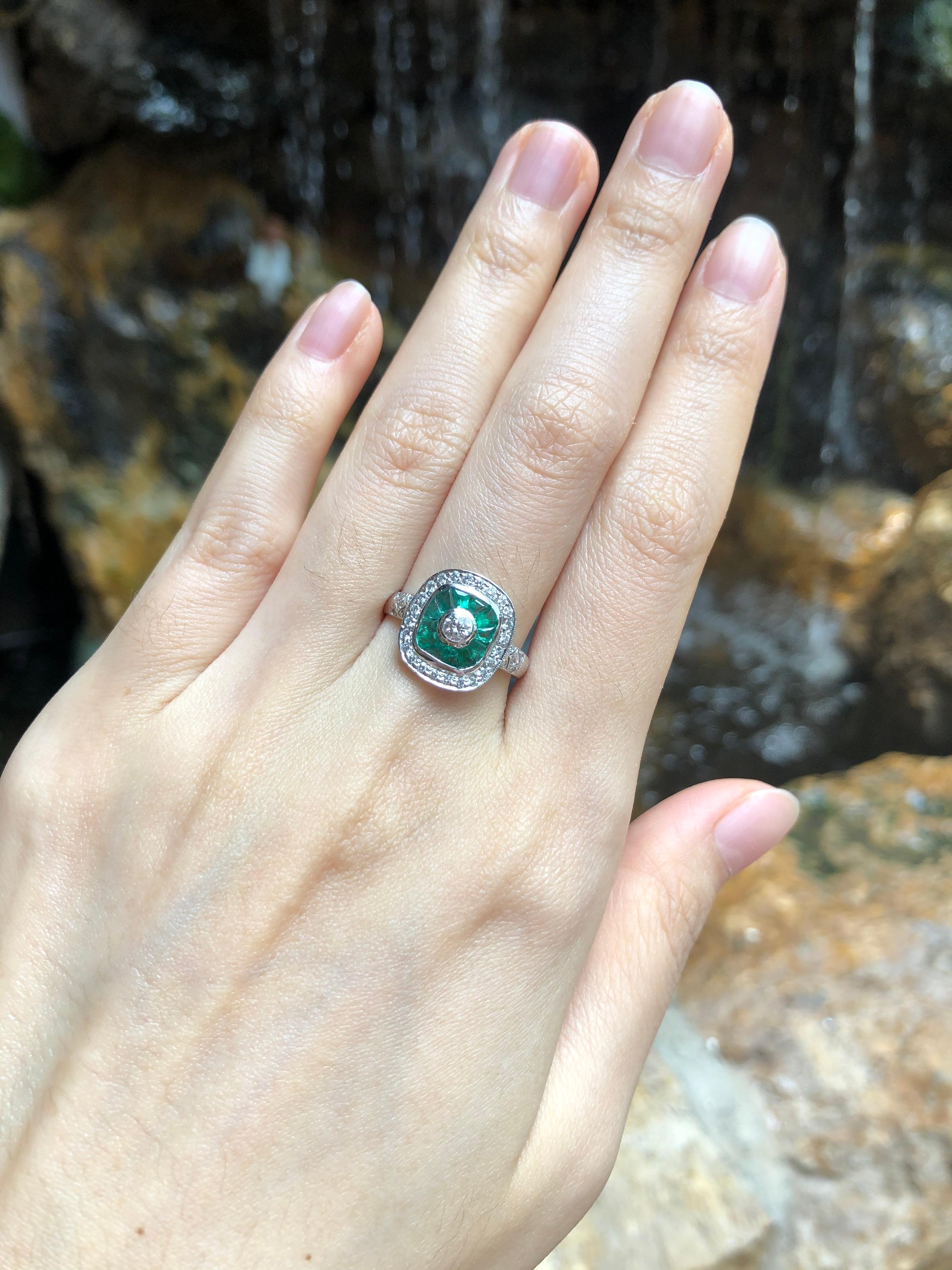 Emerald 0.70 carat with Diamond 0.37 carat Ring set in 18 Karat White Gold Settings

Width:  1.2 cm 
Length: 1.3 cm
Ring Size: 54
Total Weight: 3.14 grams

