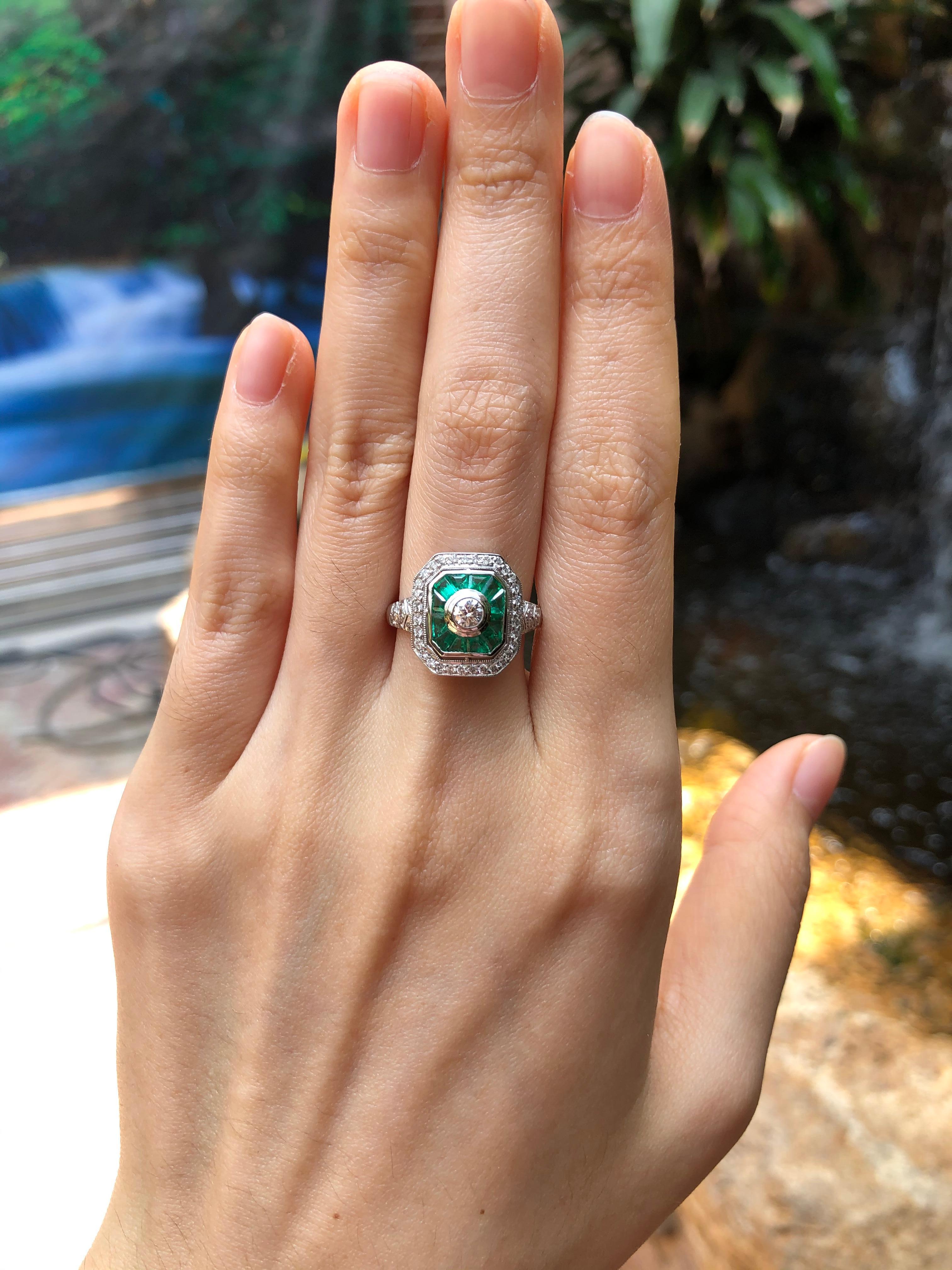 Emerald 0.60 carats with Diamond 0.51 carat Ring set in 18 Karat White Gold Settings

Width:  1.3 cm 
Length: 1.4 cm
Ring Size: 55
Total Weight: 4.46 grams

