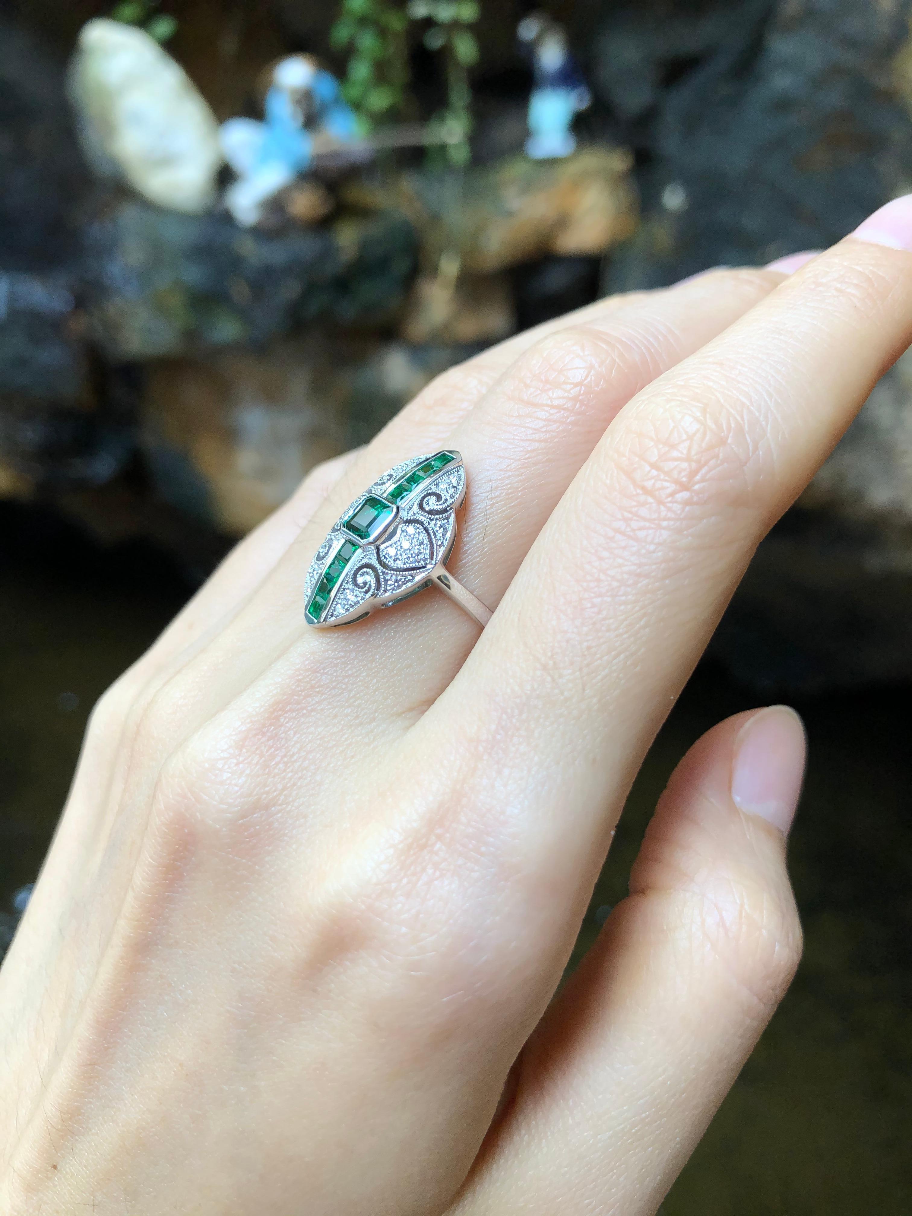 Emerald 0.80 carat with Diamond 0.14 carat Ring set in 18 Karat White Gold Settings

Width:  1.4 cm 
Length: 2.2 cm
Ring Size: 52
Total Weight: 5.89 grams

