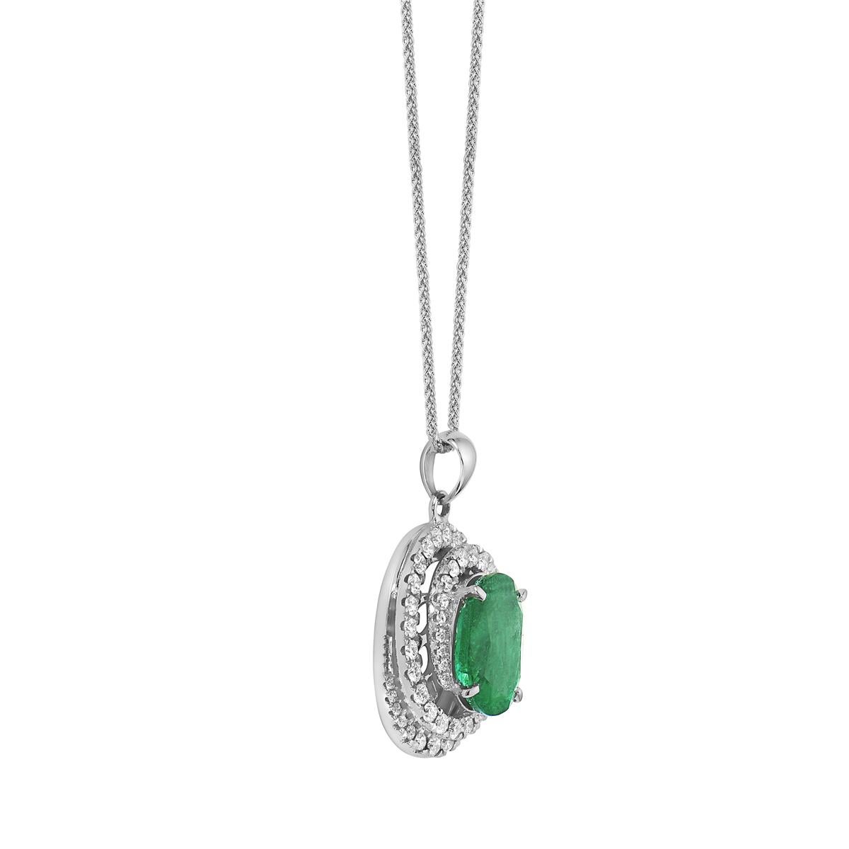 This beautiful pendant has a 3.04 CT oval emerald is surrounded by a diamond spiral halo made of 54, 0.74 CT round diamonds. It is made of 4.9 grams of 18 karat white gold and hung from an 18 karat white gold wheat chain that can be worn at 16, 17,