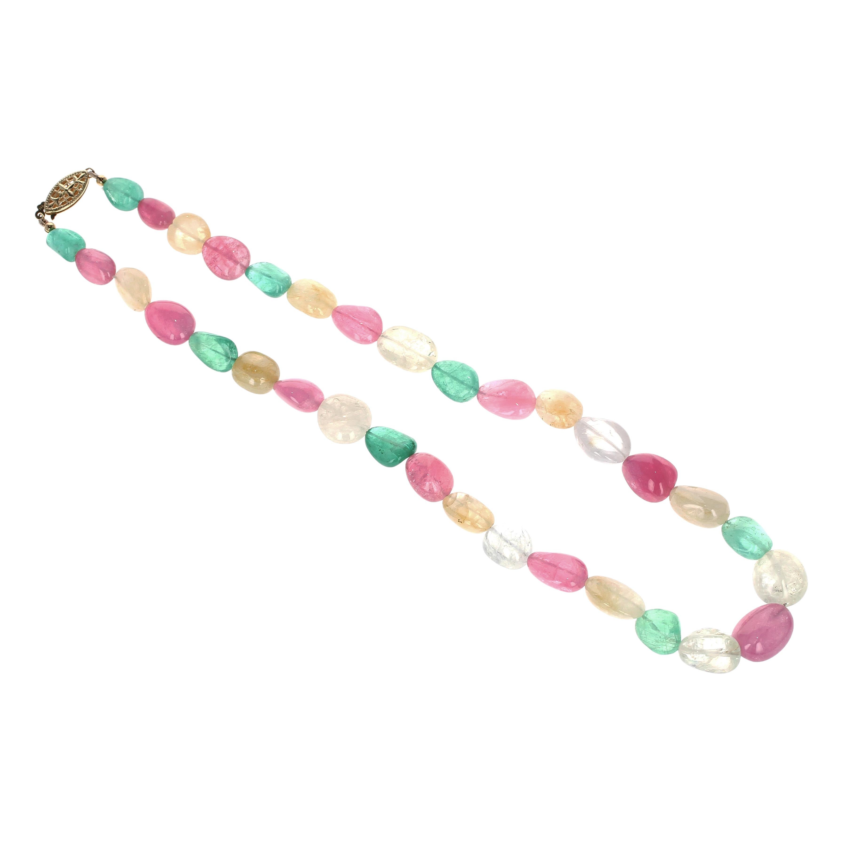 A uniquely and aesthetically matched bead necklace of emerald, yellow sapphire, and pink tourmaline strung in a single row clasped with 14kt yellow gold; the necklace weighs approximately 305.70 carats and measures 18 inches in length.
