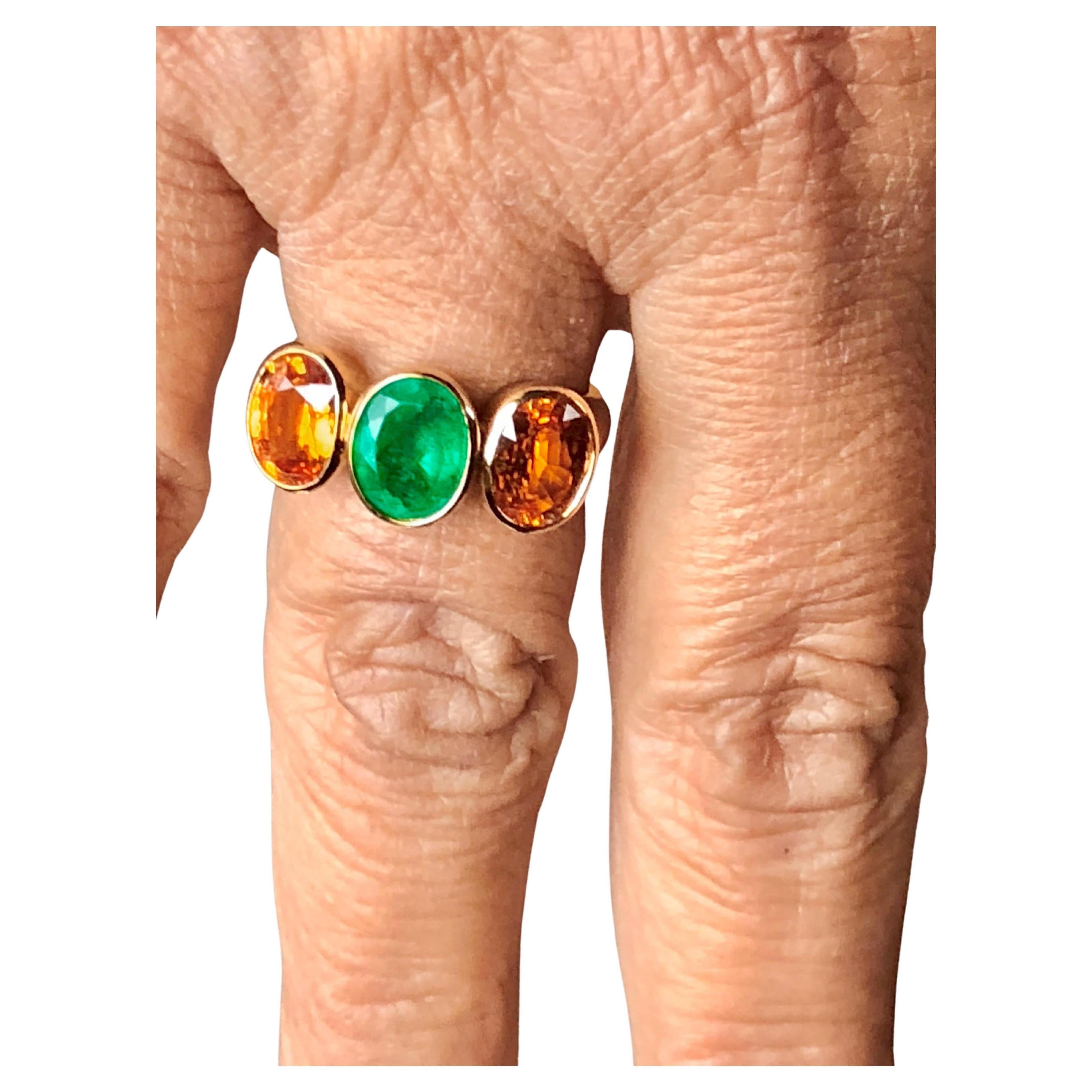 STUNNING natural yellow sapphire and natural Colombian emerald three-stone engagement ring. Set in 18k yellow gold setting. 
Center Stones: Natural Oval Emerald
Color/Clarity Emerald: Fine AAA Intense Medium Green /Very Clean,VS
Total Weight