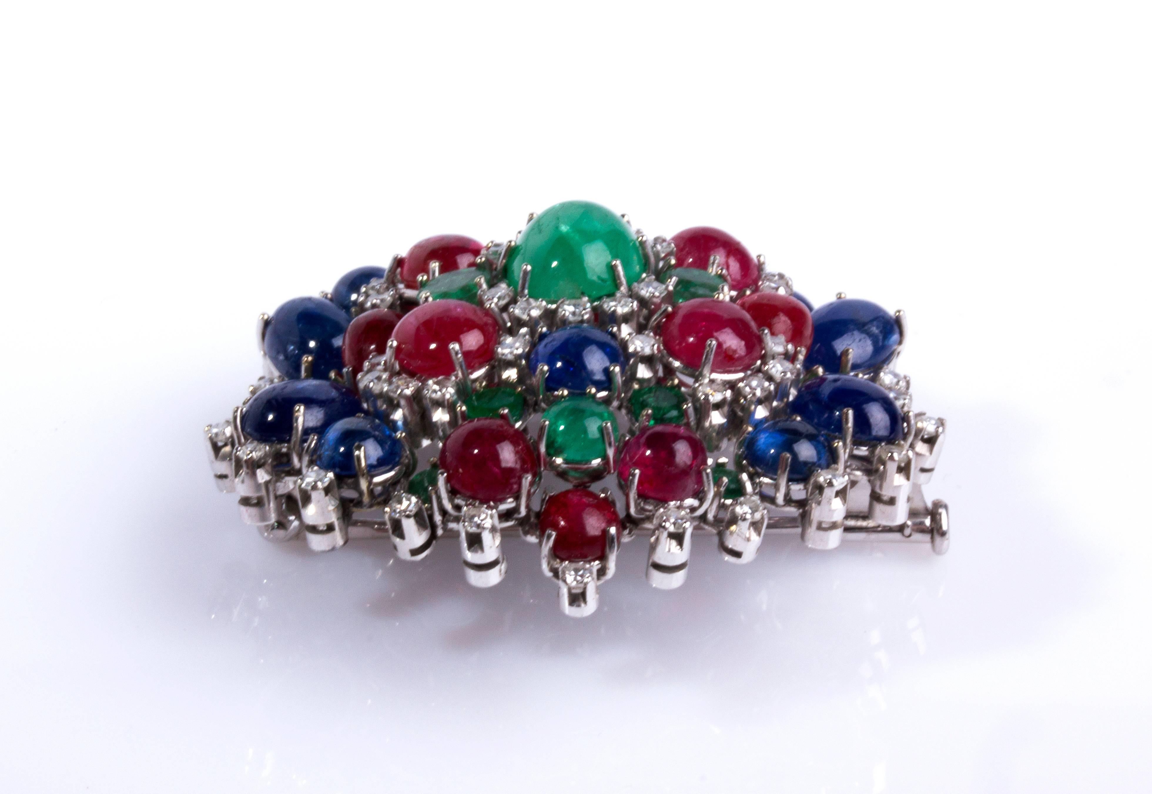 Shaped as a flower, set cabochon emerald,sapphire and ruby, embellished with brilliant cut diamond weighing 2.50 ct.
