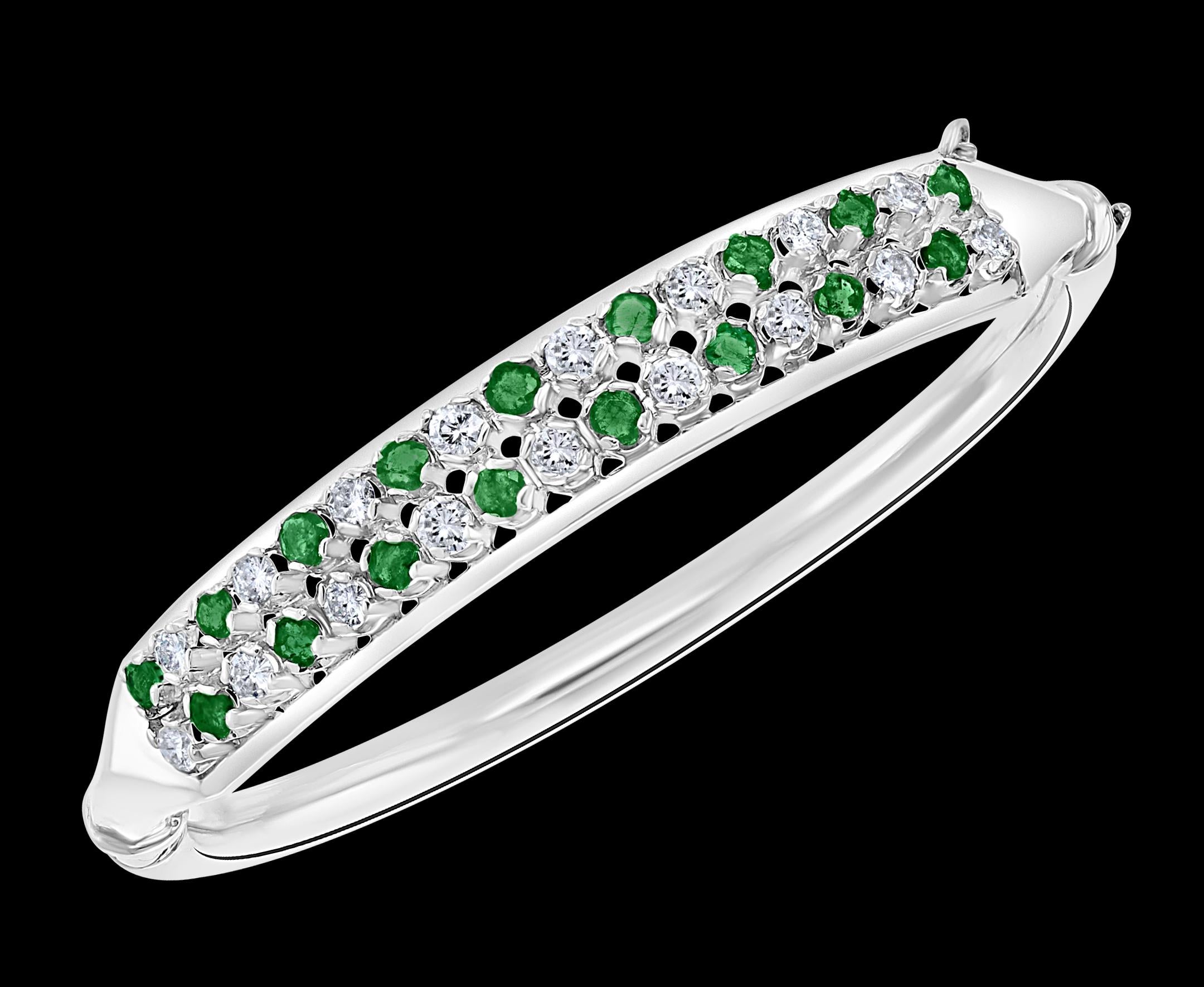 Emeralds And  Diamonds 14 Karat  White Gold 20 Grams Bangle /Bracelet
It features a bangle crafted with  14 karat heavy White gold .
 Two rows of Round brilliant diamonds of the top quality alternating with Round Emeralds
Opens from side for east