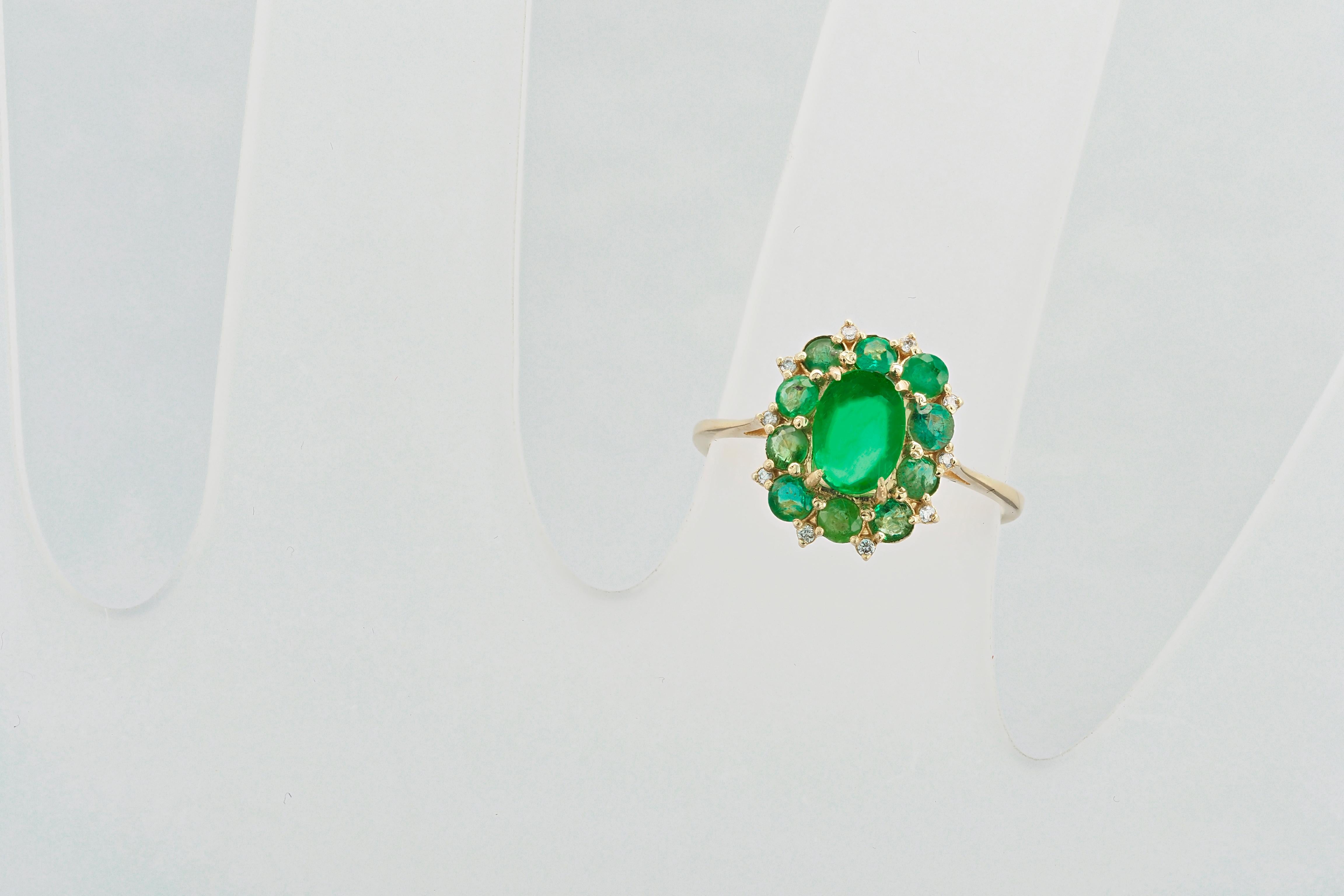 14 kt solid gold ring with natural emeralds and diamonds. May birthstone. Beautiful ring with central emerald and side emeralds and diamonds.

Total weight: 2.5 g. depends from size

Central stone: Natural emerald.
Weight: approx 0.9 -1 ct. 
Color: