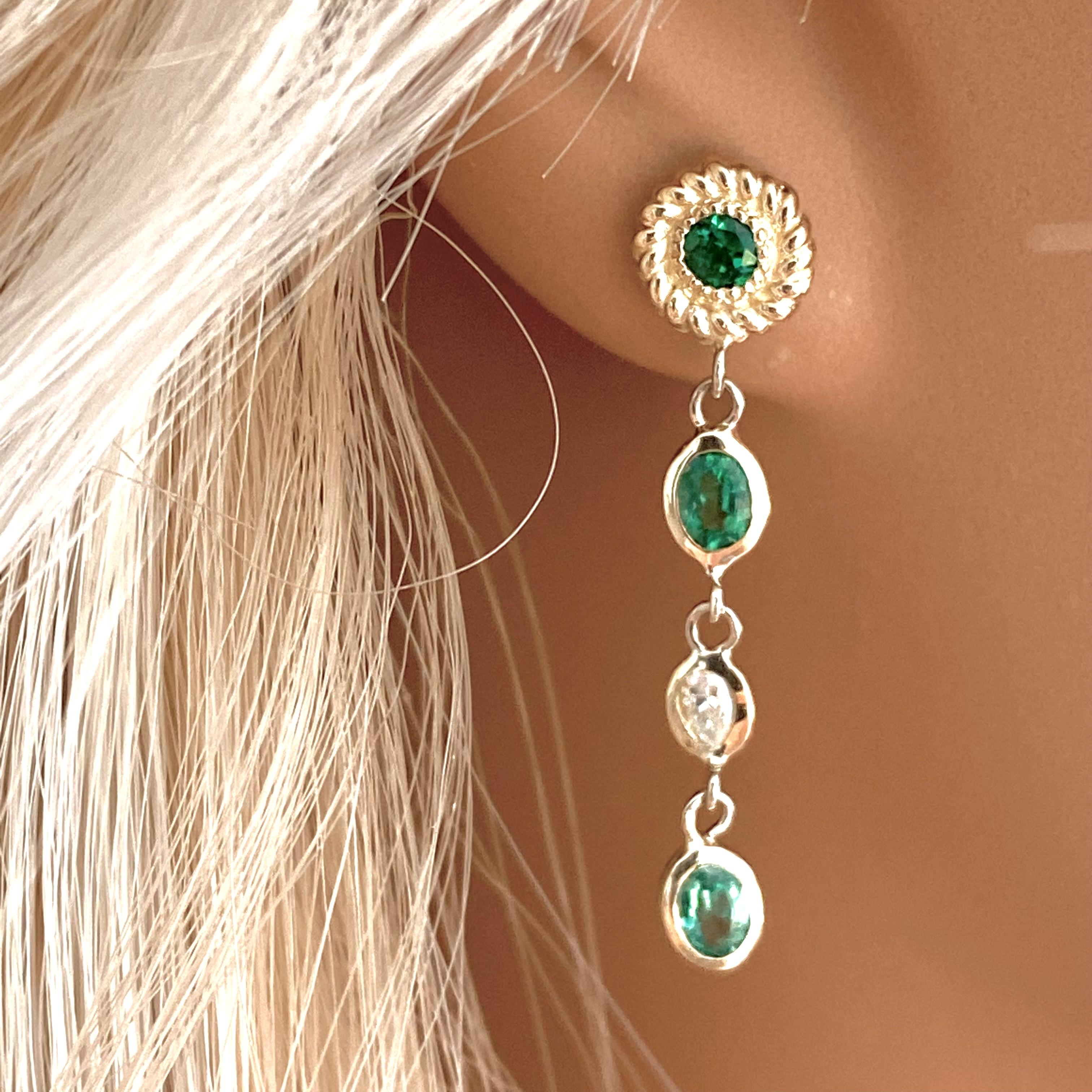 Fourteen karats yellow gold diamond and emerald drop earrings 
Four oval emeralds weighing 0.85 carats
Two round emeralds weighing 0.30 carats
Two diamond weighing 0.20 carat 
New Earrings
Handmade in the USA 
Our design team select gemstones for