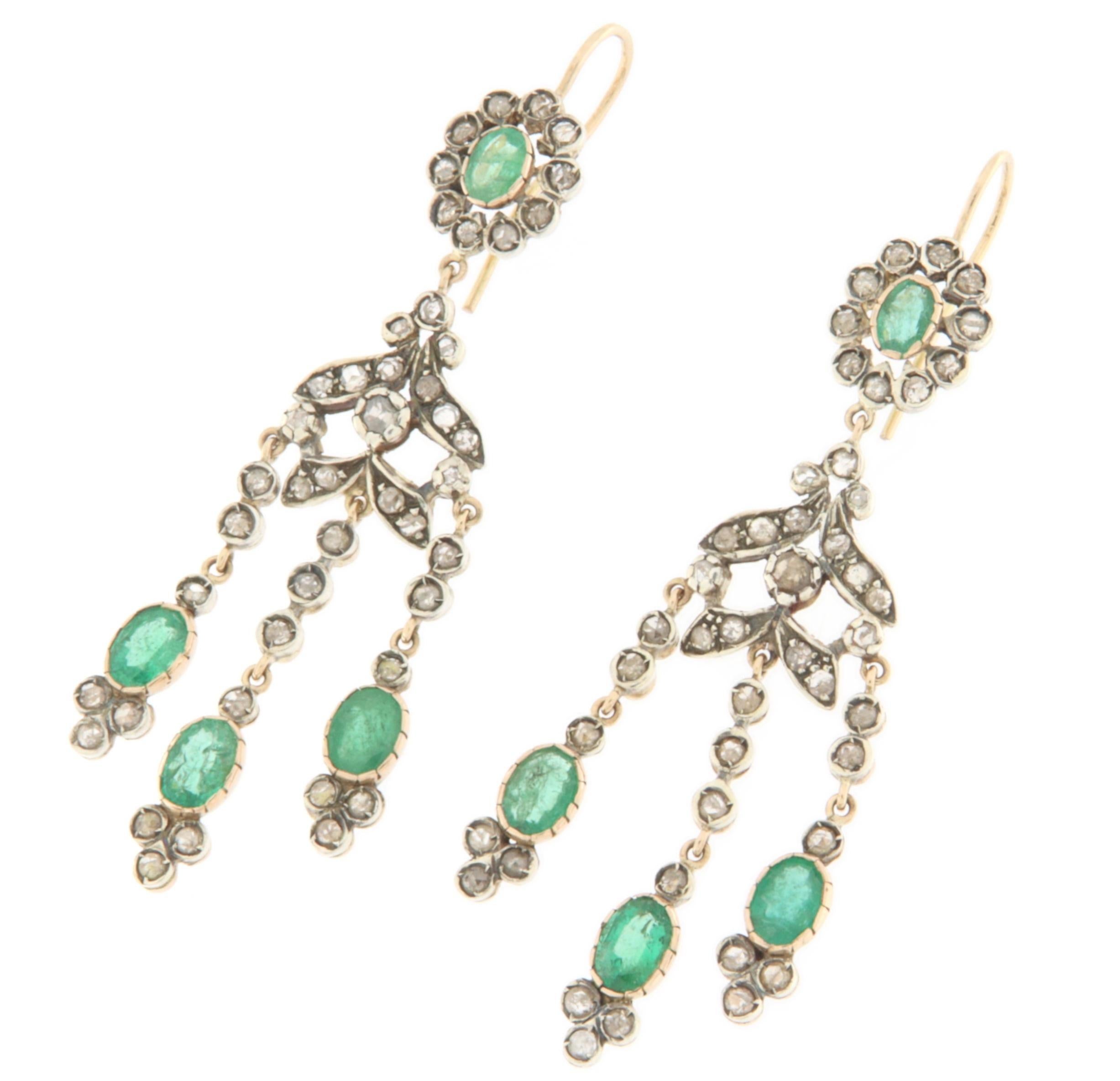 These elegant earrings, crafted in 14-karat yellow gold and 800 silver, are a refined example of artisanal craftsmanship, enriched with emeralds and rose-cut diamonds, offering a sophisticated and timeless look. The combination of yellow gold and