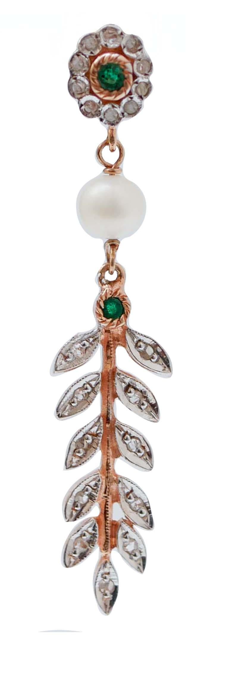 Amazing earrings in 9 kt rose gold and silver structure mounted with a flower of diamonds and a central emerald in the upper part. In the middle, a pearl and, below, an emerald  and a  rain of leaves studded with diamonds.
These earrings were
