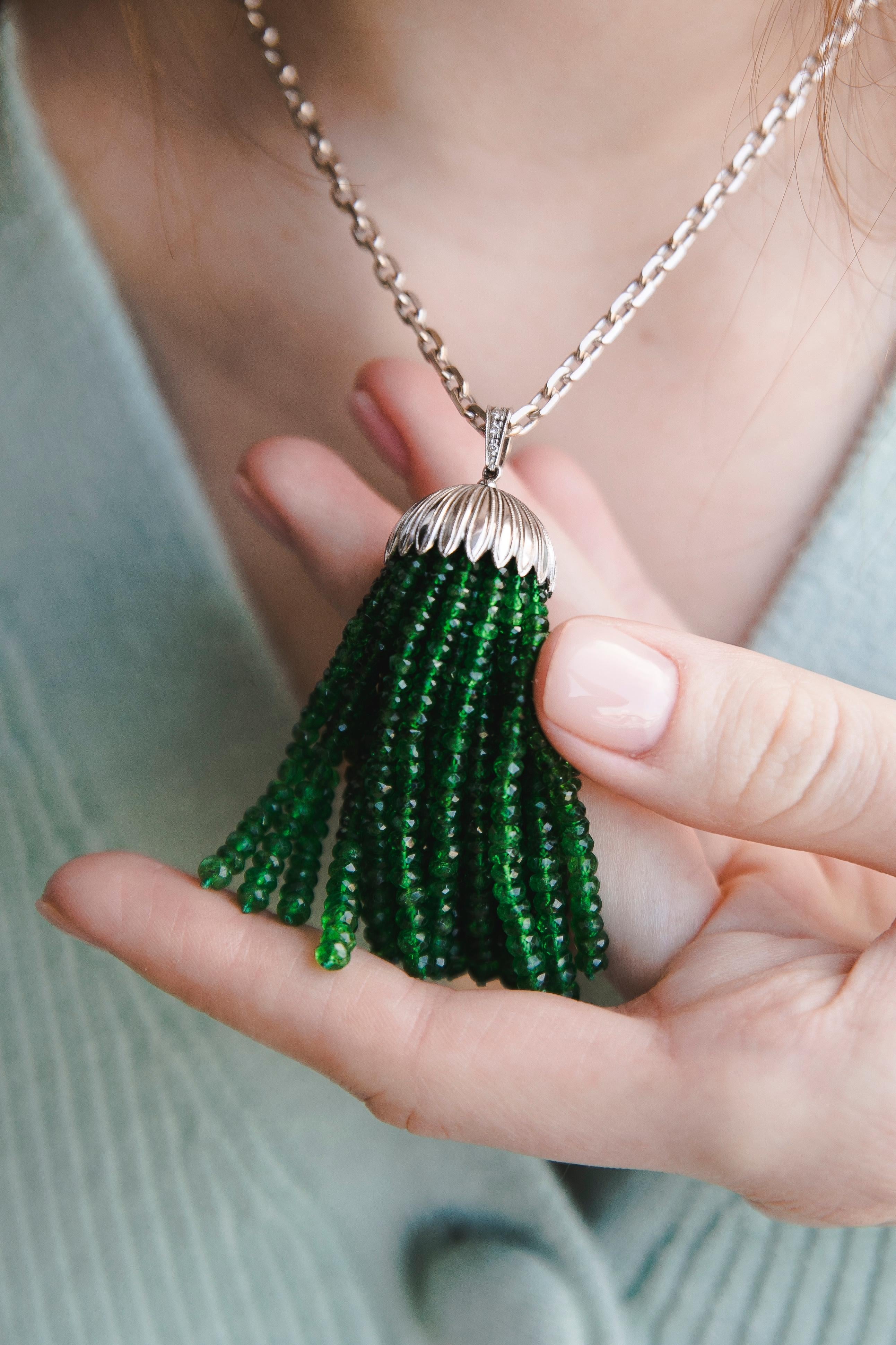 Emeralds Diamonds Platinum Pendant Chain. Created around 1920.
Platinum Pendant with Emeralds beads on a white Gold chain. The pendant consists of a Platinum dome with 30 separate and independent Emerald threads. The loop between the dome and the