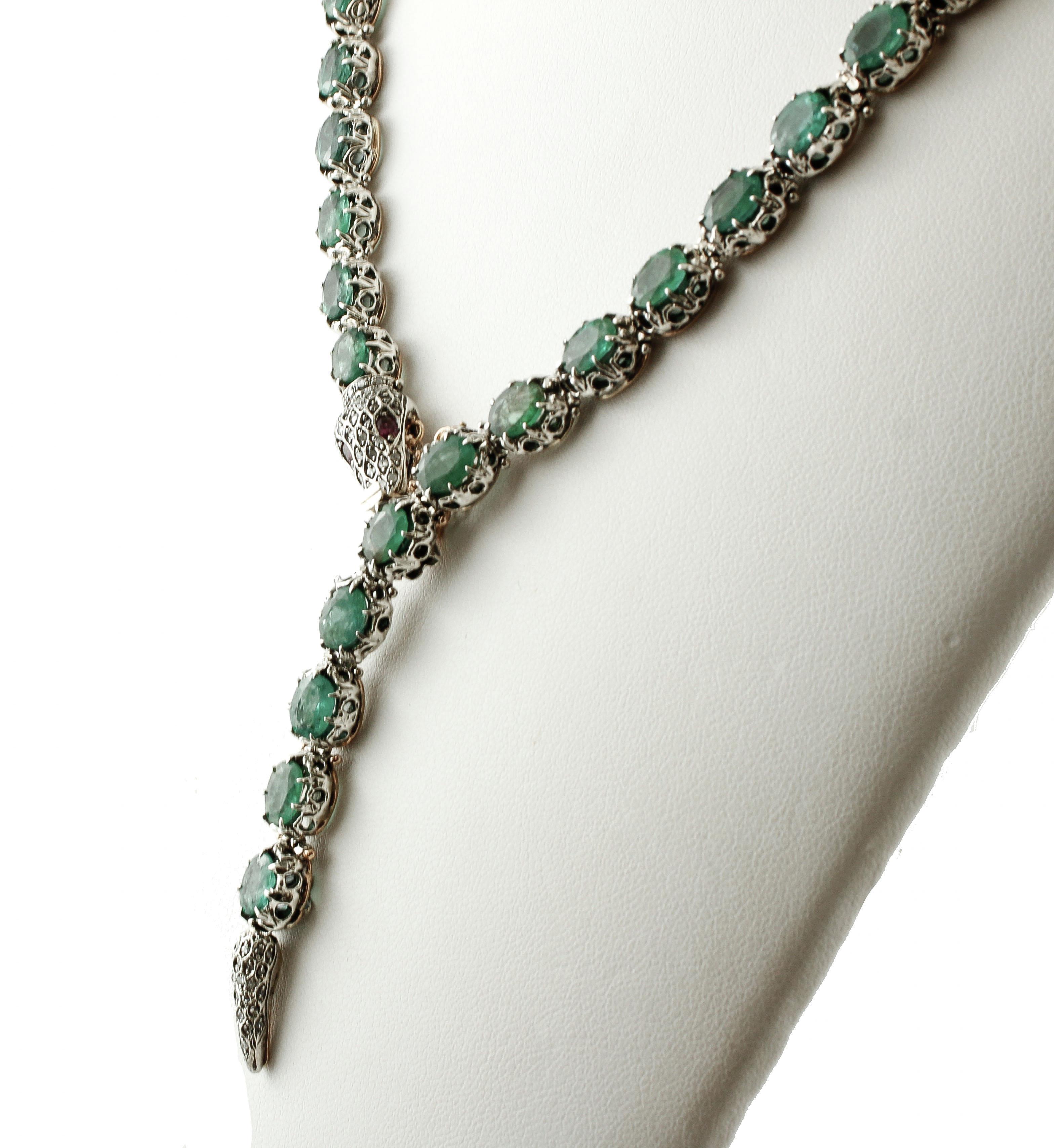 Marvelous retro snake necklace realized in 9k yellow gold and silver structure, and mounted with 62 intense emeralds along the snake body, 2 rubies as eyes, and little diamonds on the snake head and tail. 
This special necklace is totally handmade