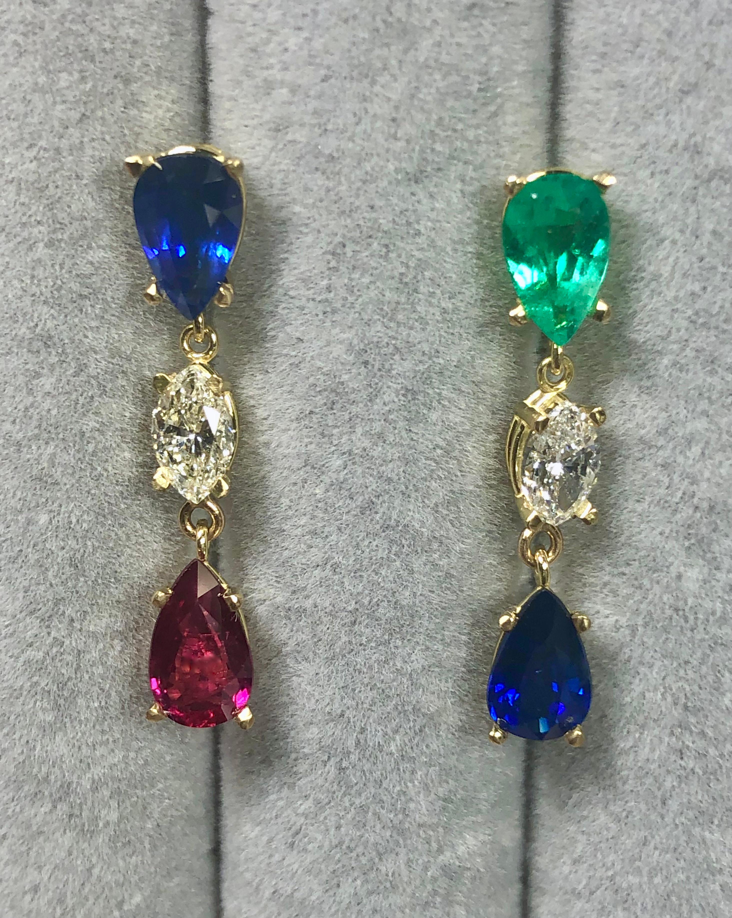 Extraordinary drop dangle earrings designed with blue Burma sapphire, Intense green Colombian emerald, vivid red ruby, and sparkling diamonds. All the natural color gemstones are pear-cut, they have excellent clarity and transparency, bold color.