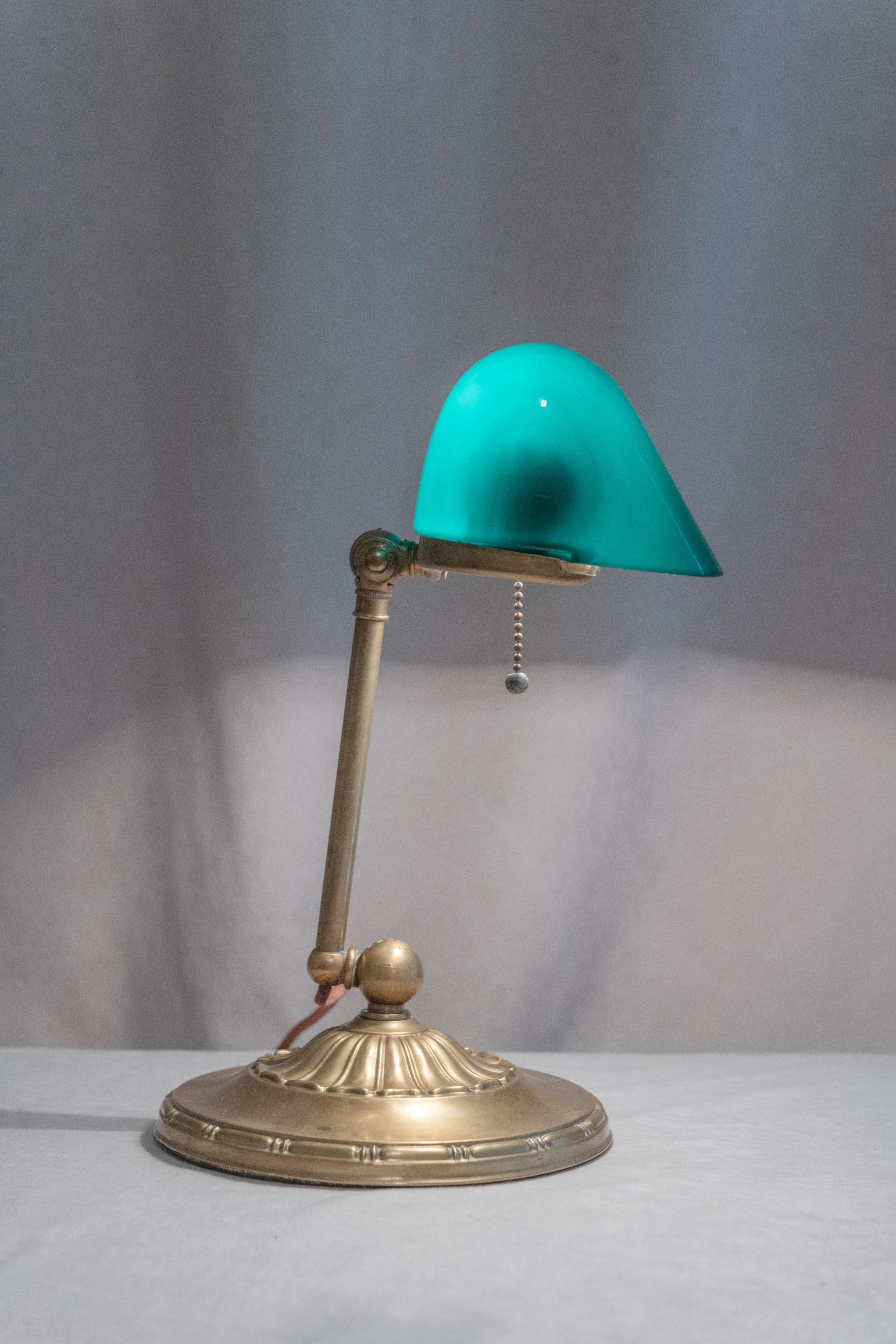  These lamps which have come to b known as banker's lamps are the most popular antique lamp for use on one's desk. Emeralite, the maker of this lamp is by far the most well known. Signed inside the the back of the shade as well as on the underside