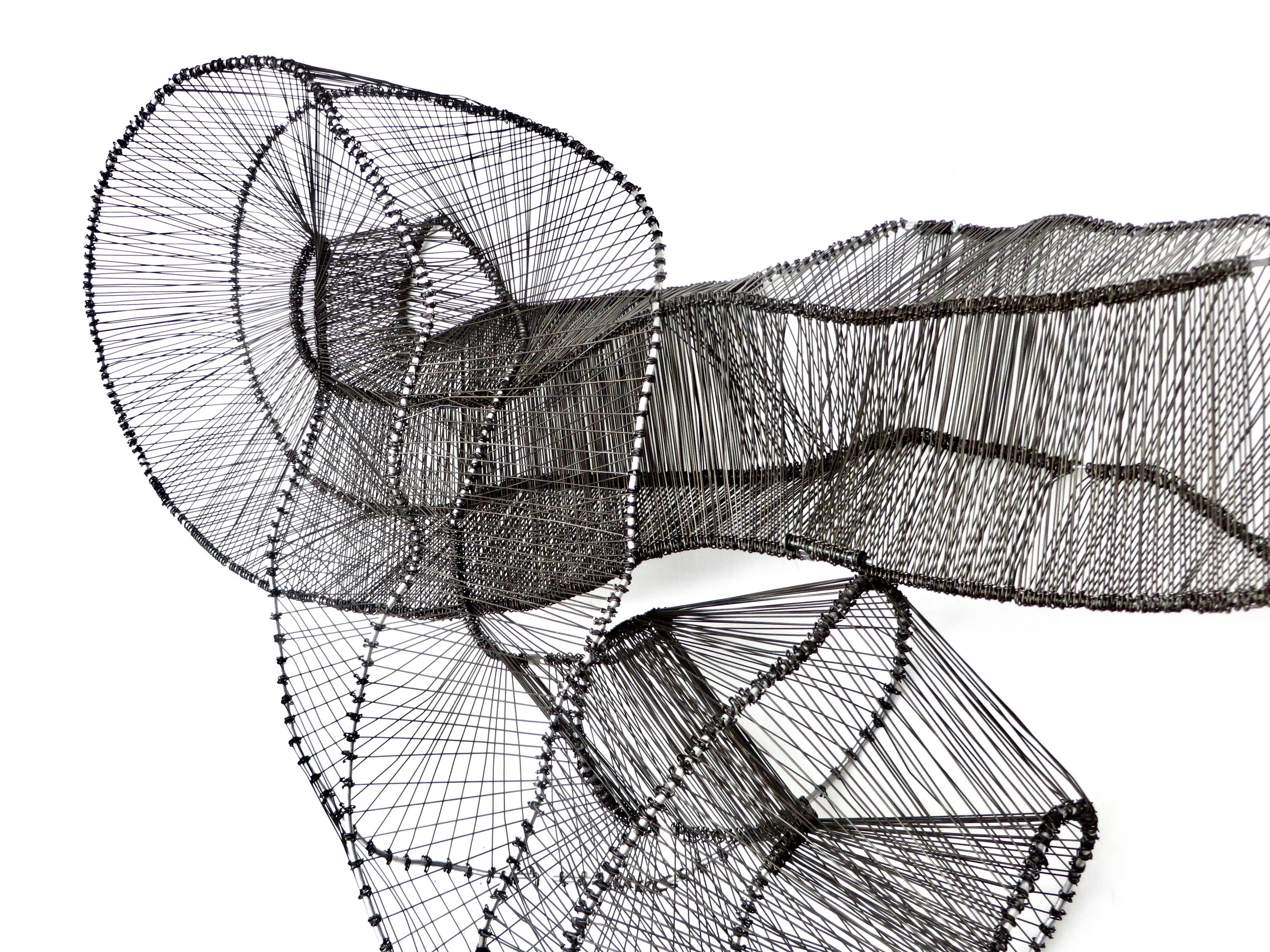 Chicago based artist Eric Gushee, has created a body of work called the Emergence Series. This sculpture is a piece unique variation, incorporating the Mobius strip as a design structure. Made of stainless steel and black anodized steel wire, the