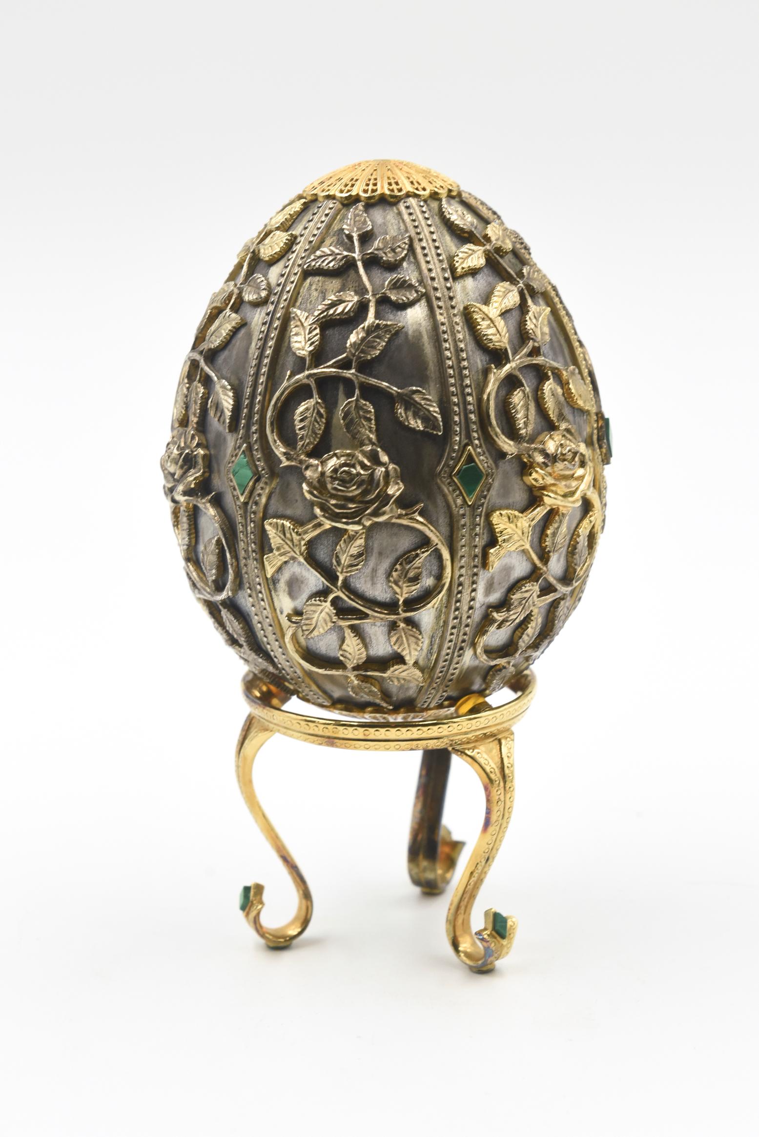 Description from Franklin MInt:
House of Faberge Egg 13.45 troy ozs Sterling Silver Vermeil with Malachite Stand Franklin MInt, 1977 Emergence of Spring Filigree Butterfly Egg, 925 Vermeil Stand (18k Bee Brooch - This piece is missing), Numbered 23,