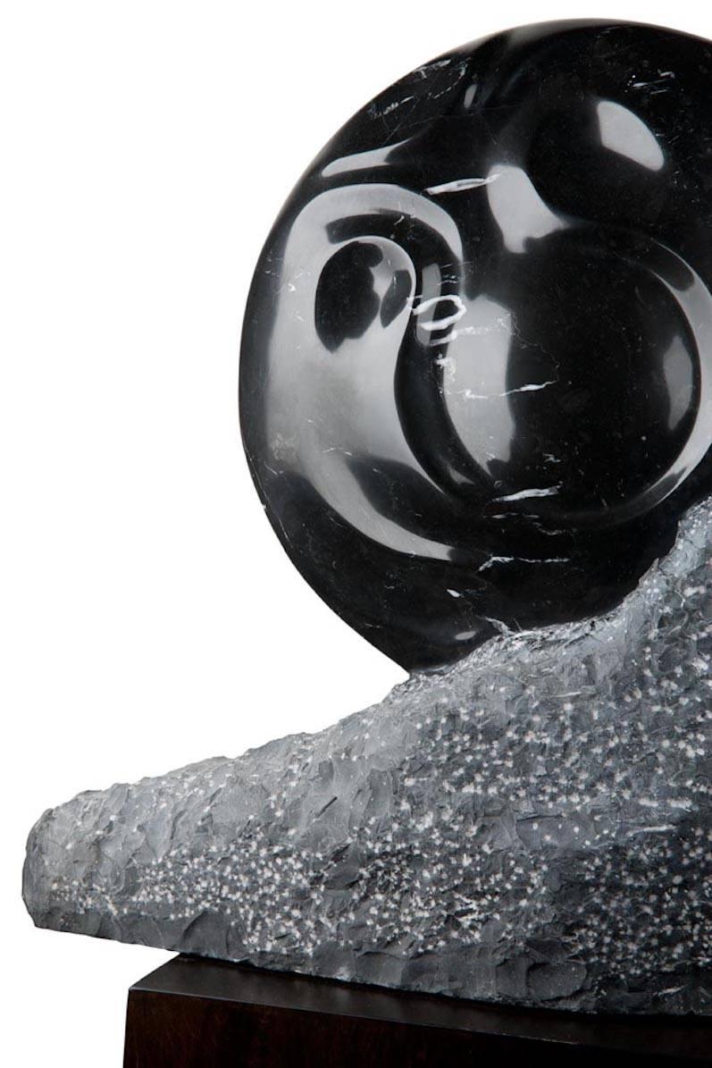 A black marble sun dwarfs the horizon, a glimmering and polished sphere of radiance over a textured mountain peak. This Hector Alvarado piece is bold and hopeful, the promise of new beginnings.

Black marble sculpture by Hector Alvarado

Hector