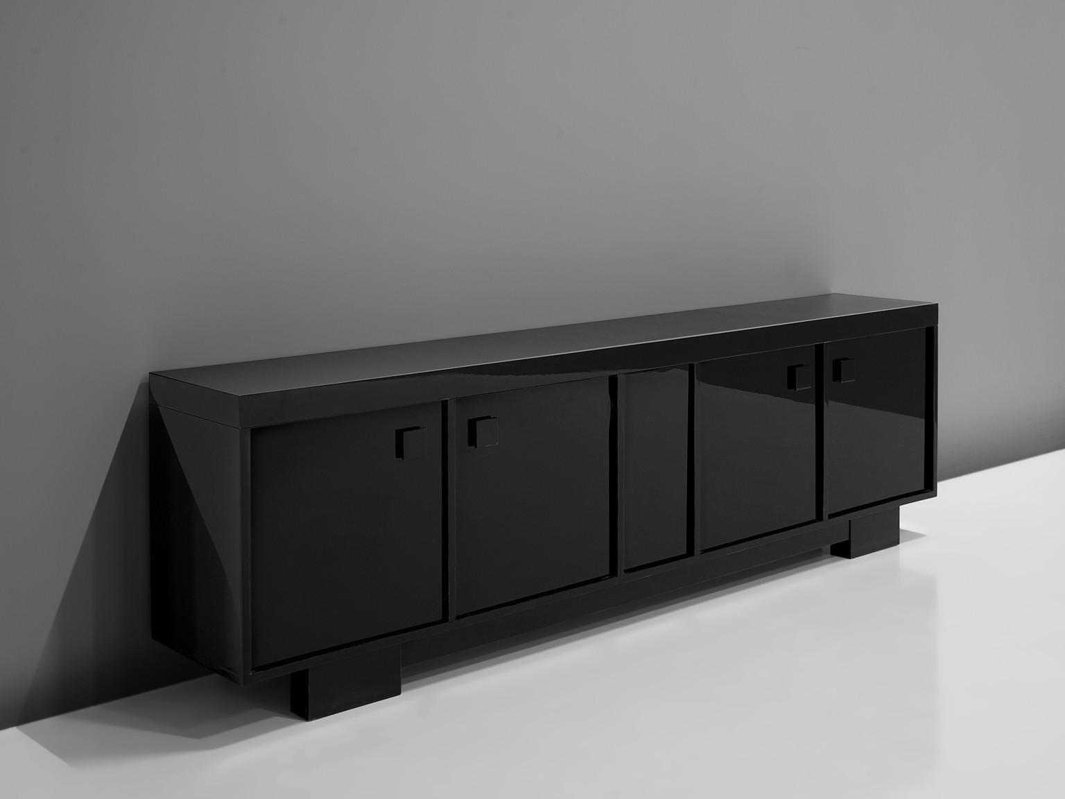 Emiel Veranneman, sideboard, high gloss lacquered wood, Belgium, 1970s

This monumental, black high gloss sideboard features five doors with squared handles. Two big doors are paired at the side and in the middle is another door integrated. The