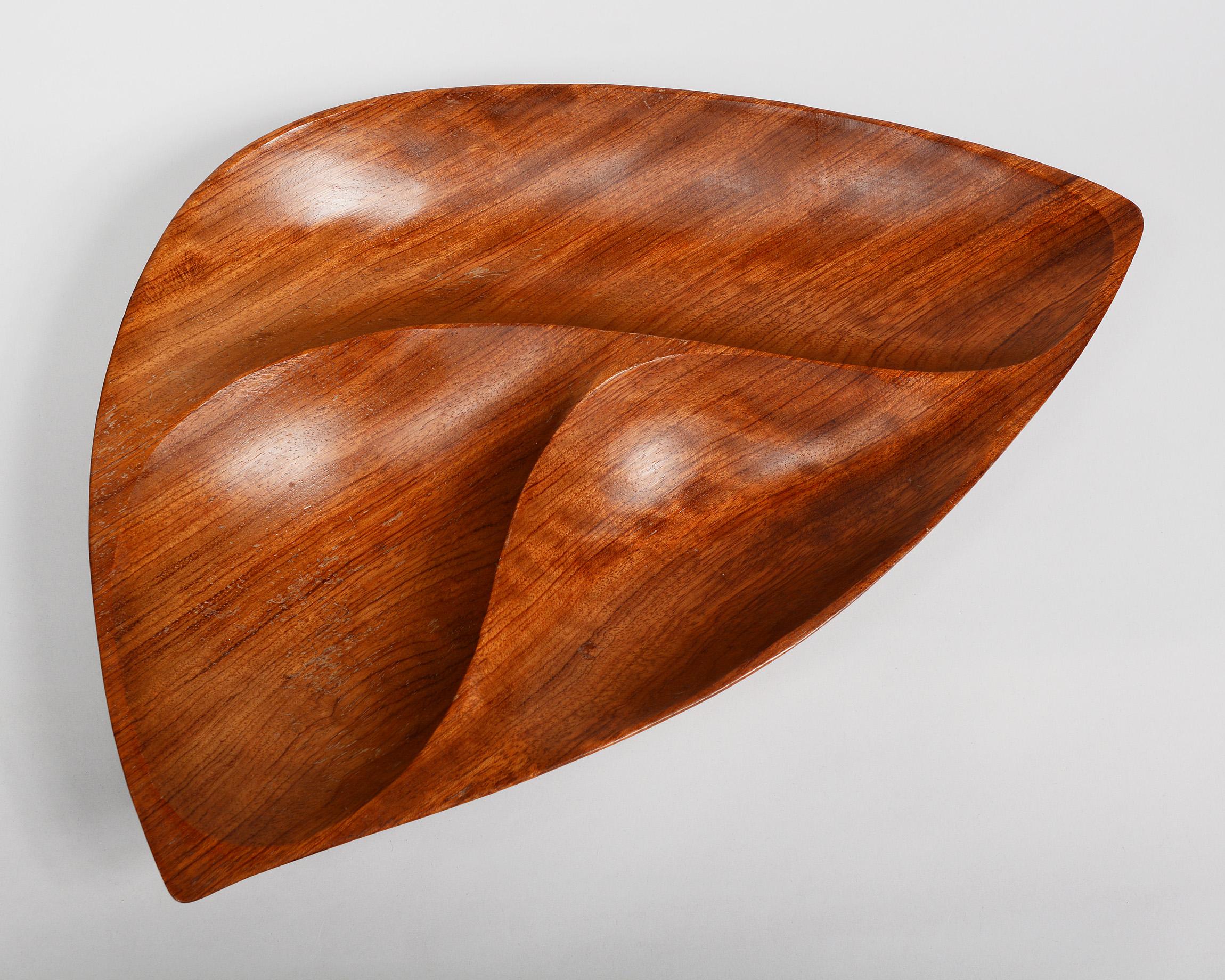 Three compartment bowl made by Emil Milan. This bowl is made from bubinga also known as African rosewood. The bowl rests on three sterling feet. There are some spots of lacquer losses.