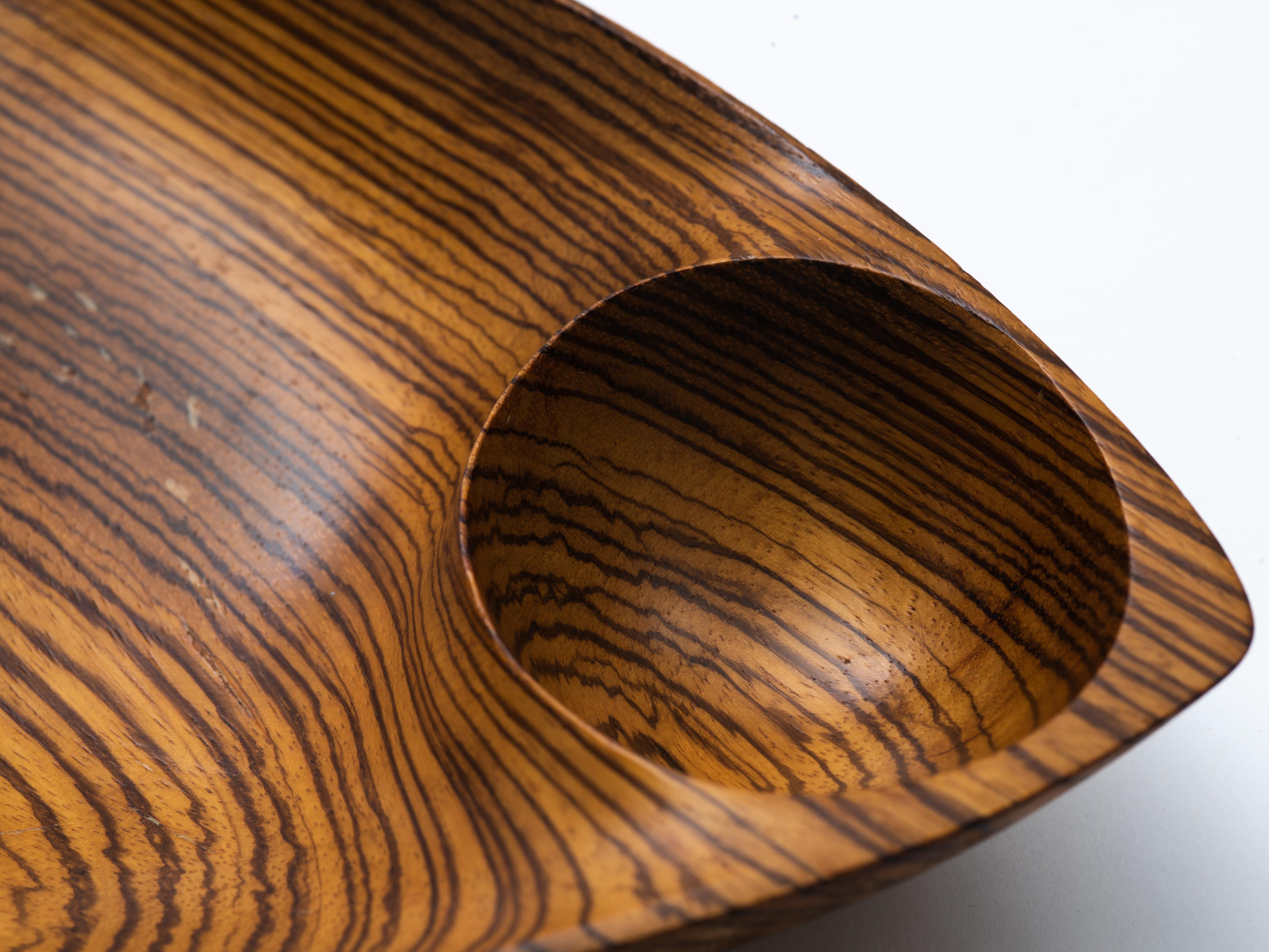 Hand carved, double-compartment, freeform bowl with handle by Emil Milan. A rare example executed in zebra wood. Signed to the underside, 