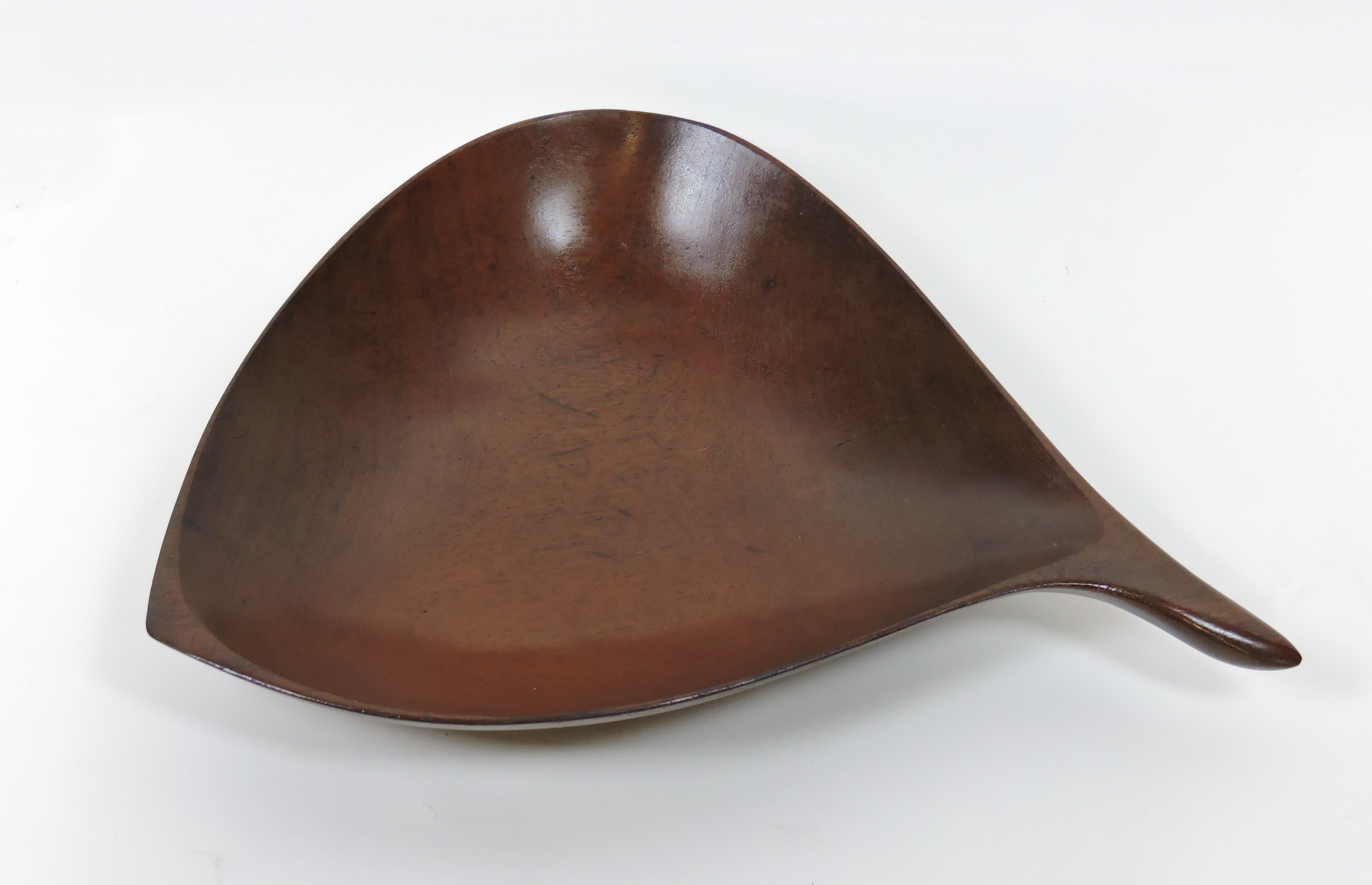 Beautiful and very large sculptural wood bowl by acclaimed American woodworker, Emil Milan. This bowl is hand carved from Bissilon, a dense wood from Africa and has a wonderful free-flowing shape. Engraved signature on the bottom - Emilan, Bissilon.