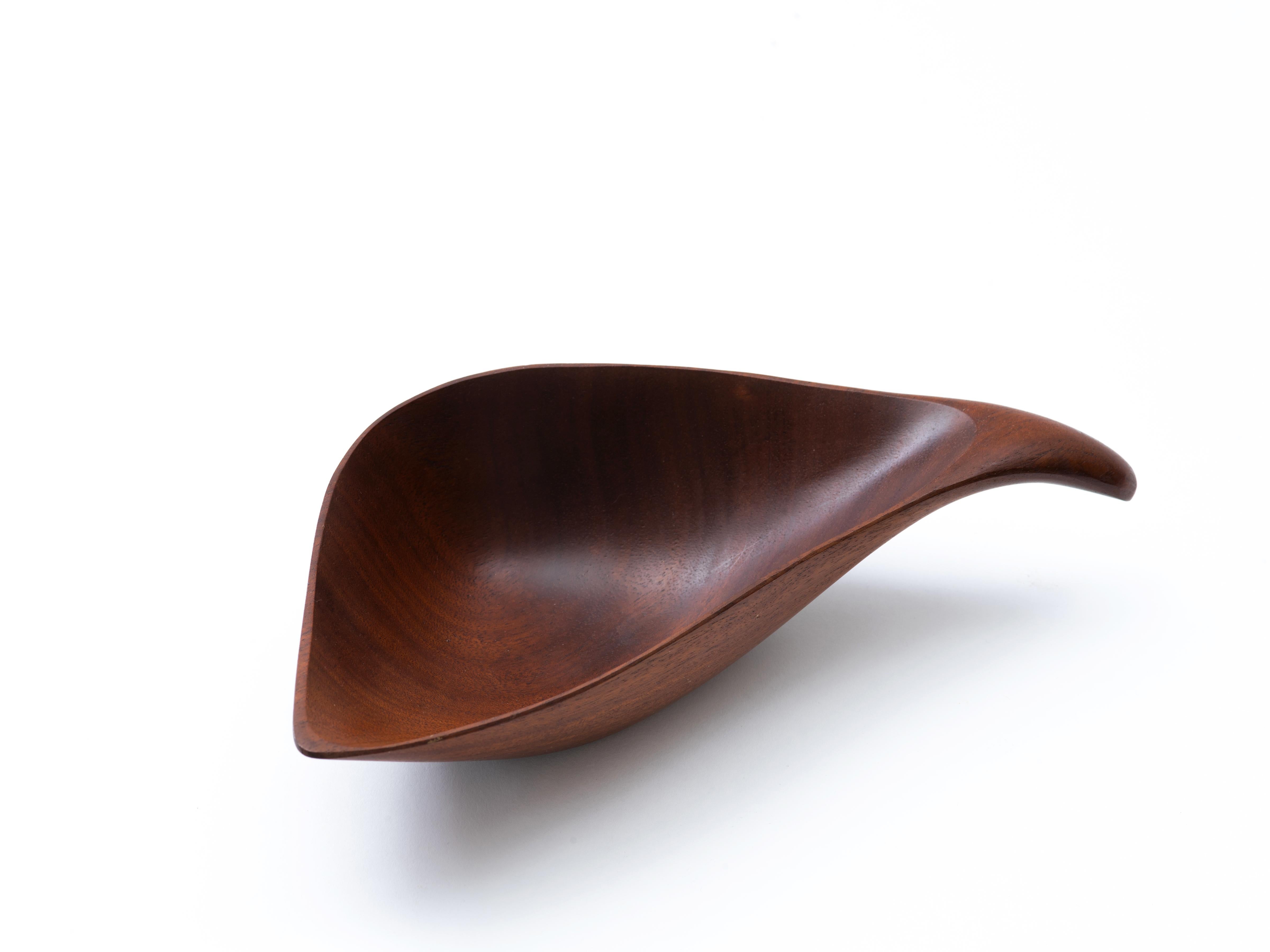 Sculptural, hand-carved vessel by American craftsman, Emil Milan (1922-85), executed in Bissilon, a species of mahogany native to Africa (and one that is approaching an endangered status). The wood hue is a deep, burnt sienna that is enhanced by the