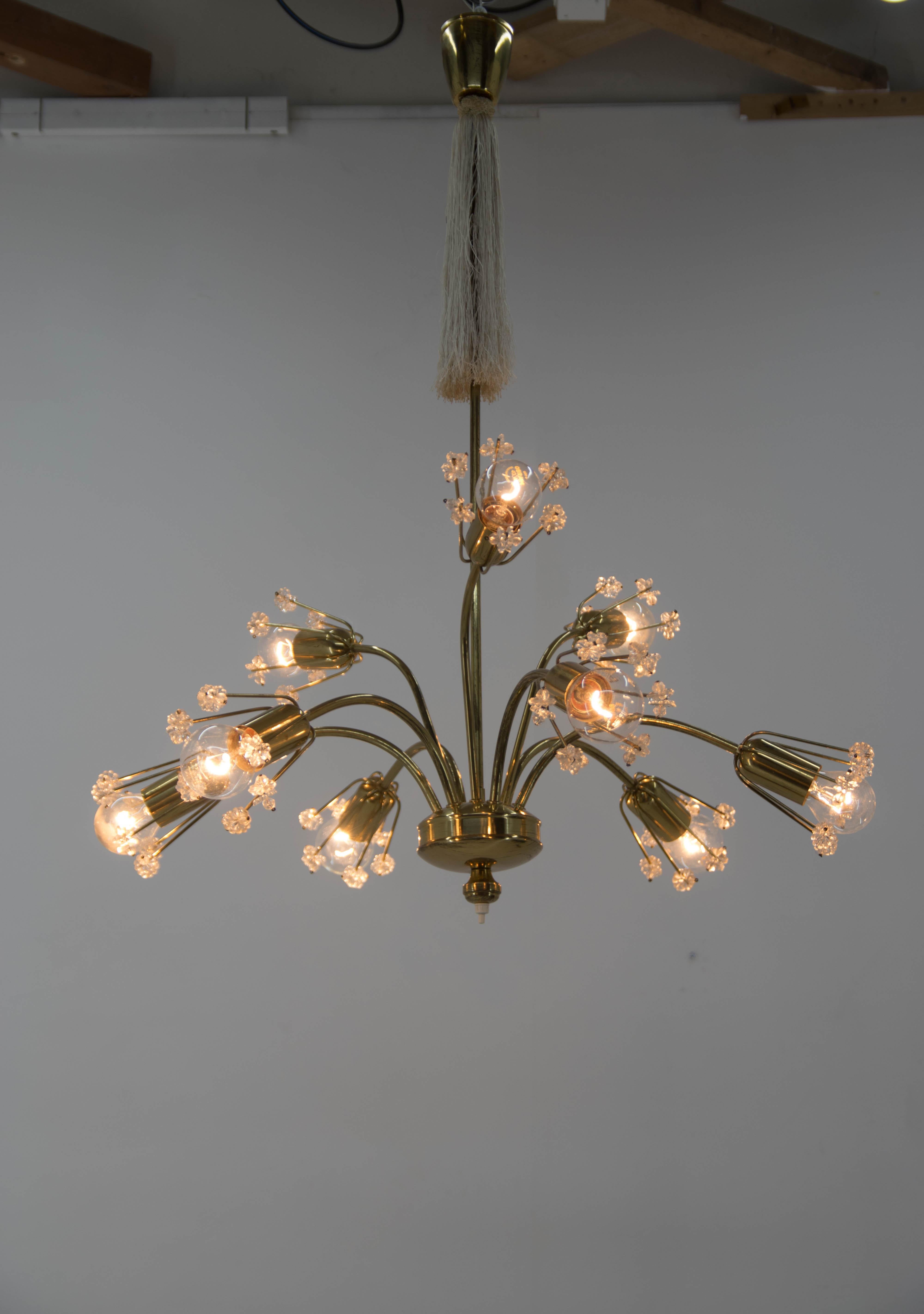 Designed in 1950s by Emil Stejnar and executed by Rupert Nikoll. Switch on the bottom part could turn off upper three bulbs. Lacquered brass with minor age patina. No crystal parts missing. 
9x40W, E12-E14 bulbs.