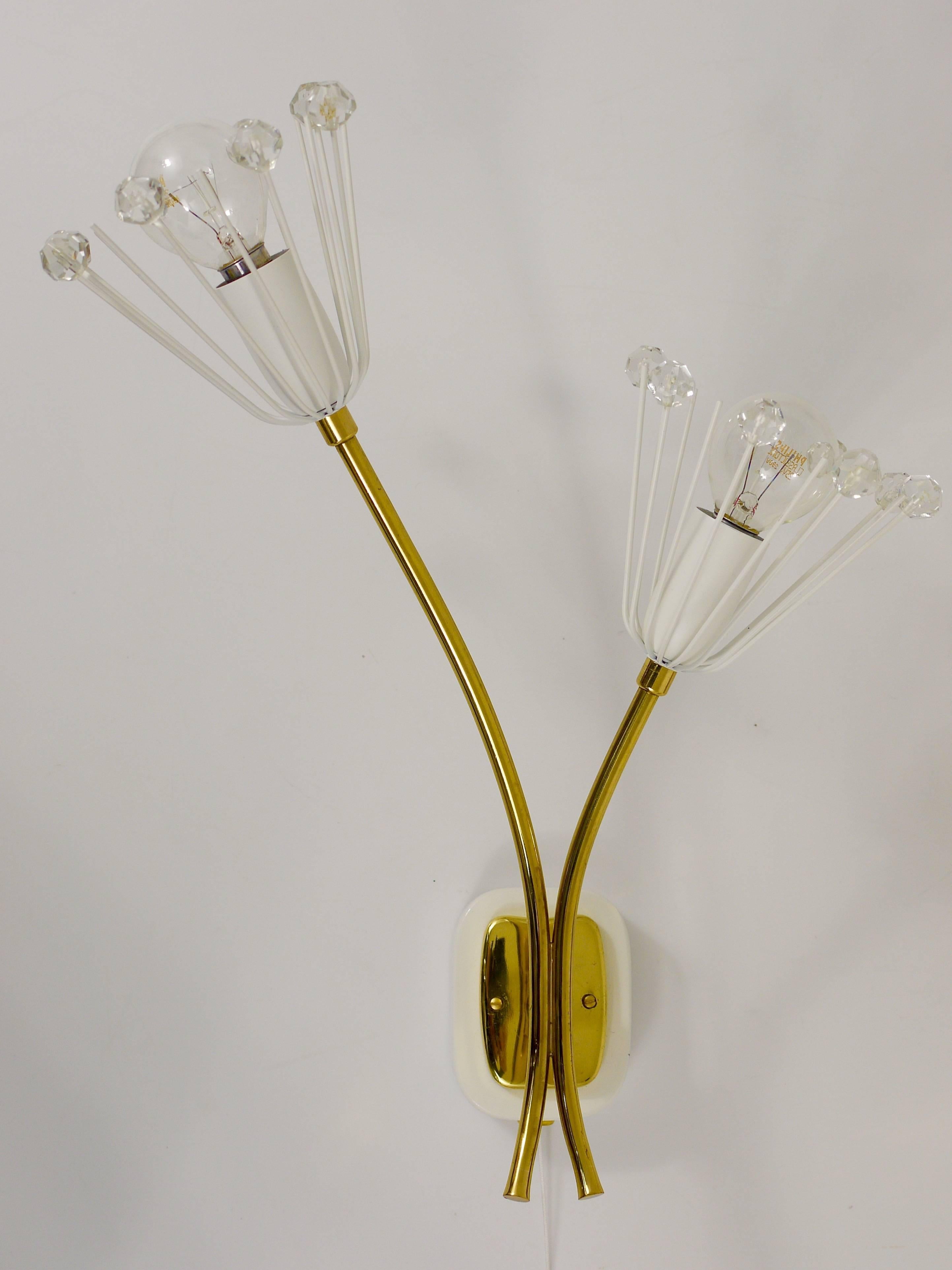 Up to 3 identical pairs of Austrian floral brass wall lights with two arms and glass crystals and integrated switches. Designed by Emil Stejnar, executed by Rupert Nikoll in the 1950s. Professionally restored and rewired, in very good condition. 3