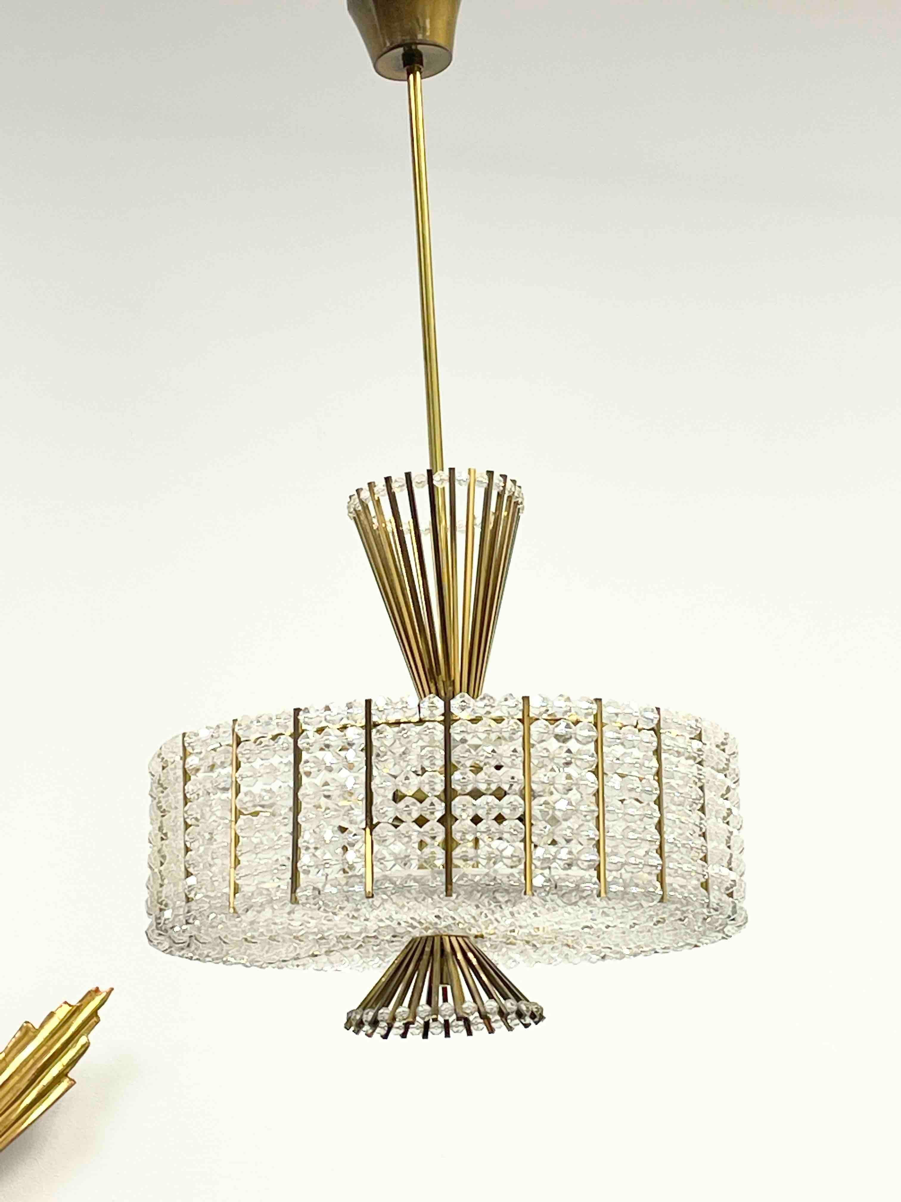 Beautiful and rare chandelier or pendant light by Emil Stejnar for Rupert Nikoll, Vienna, Austria. An original mid-century vintage piece manufactured around 1950. It is made of brass, lucite and hand-cut crystals. The Fixture requires five European