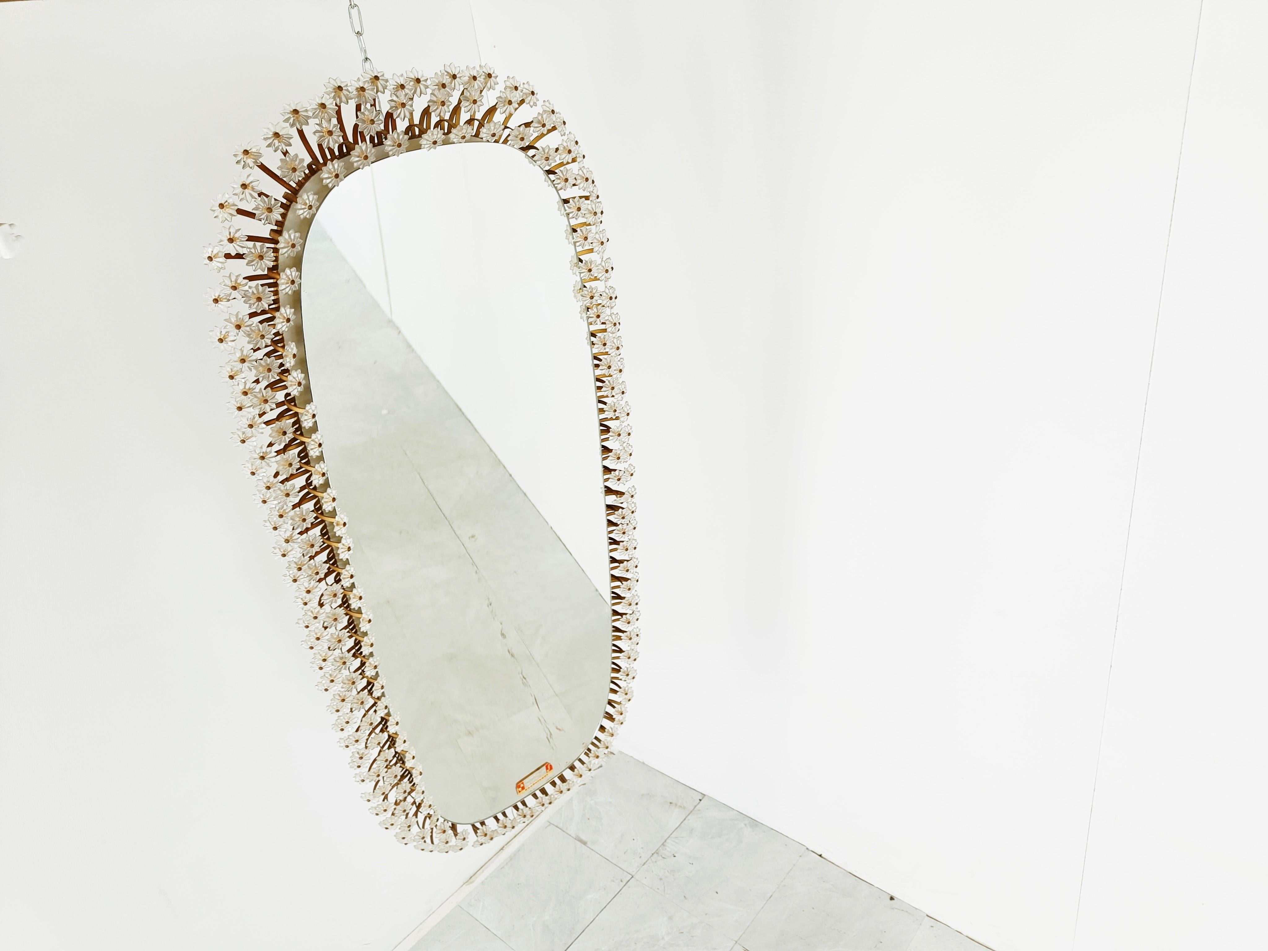 Mid century wall mirror by Emil Stejnar for Rupert Nikoll.

The mirror consists of an illuminated back with a large number of glass crystal glass flowers.

1950s - Austria

Very good condition

Tested and ready to use.

Dimensions:
Height:
