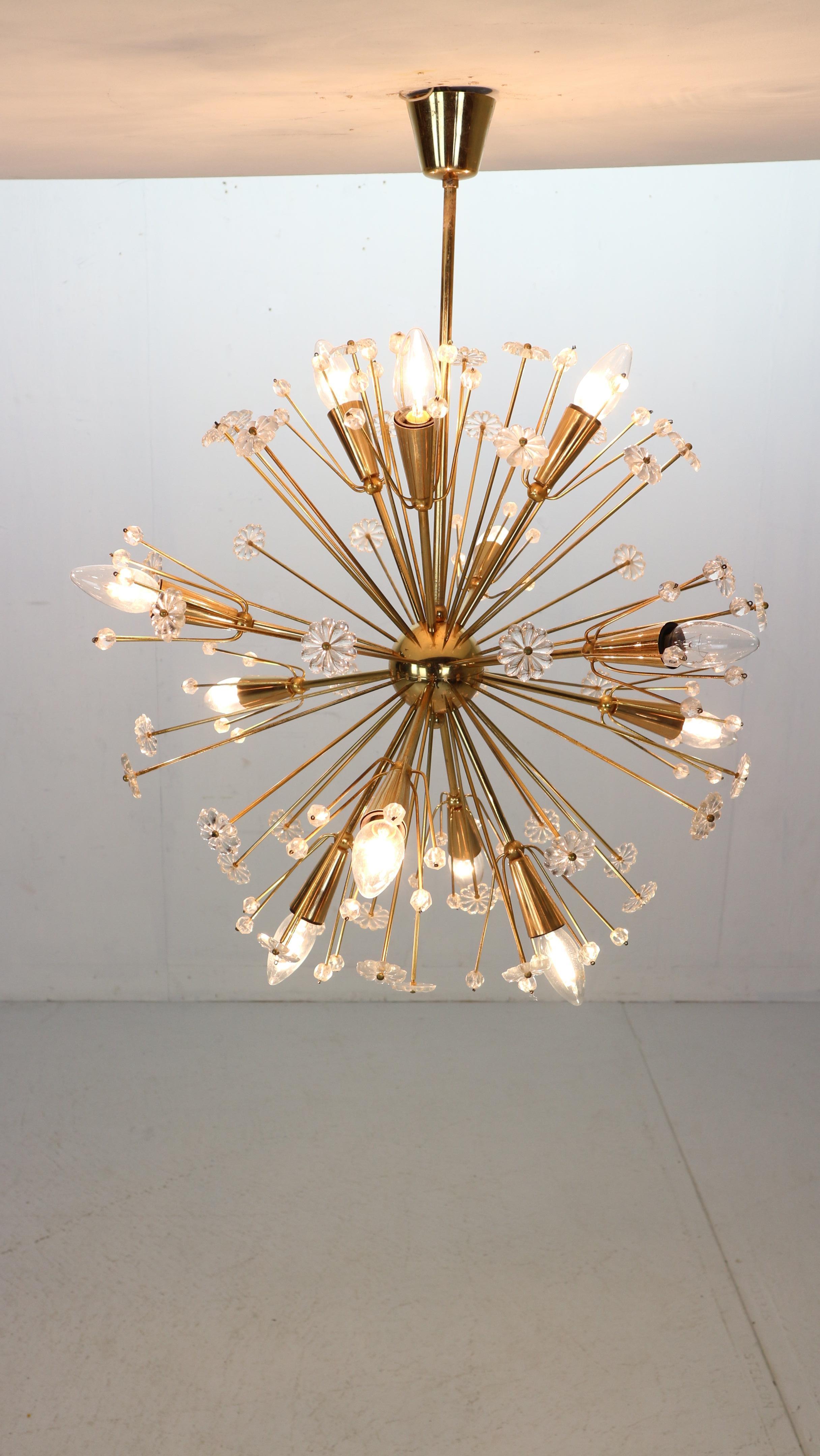 Space Age era snowflake Sputnik chandelier designed by Emil Stejnar for Rupert Nikoll, Vienna, Austria made in the 1950 period. 
Made of brass, fully covered with Austrian crystal balls and glass flowers. 
Beautiful design for a great light