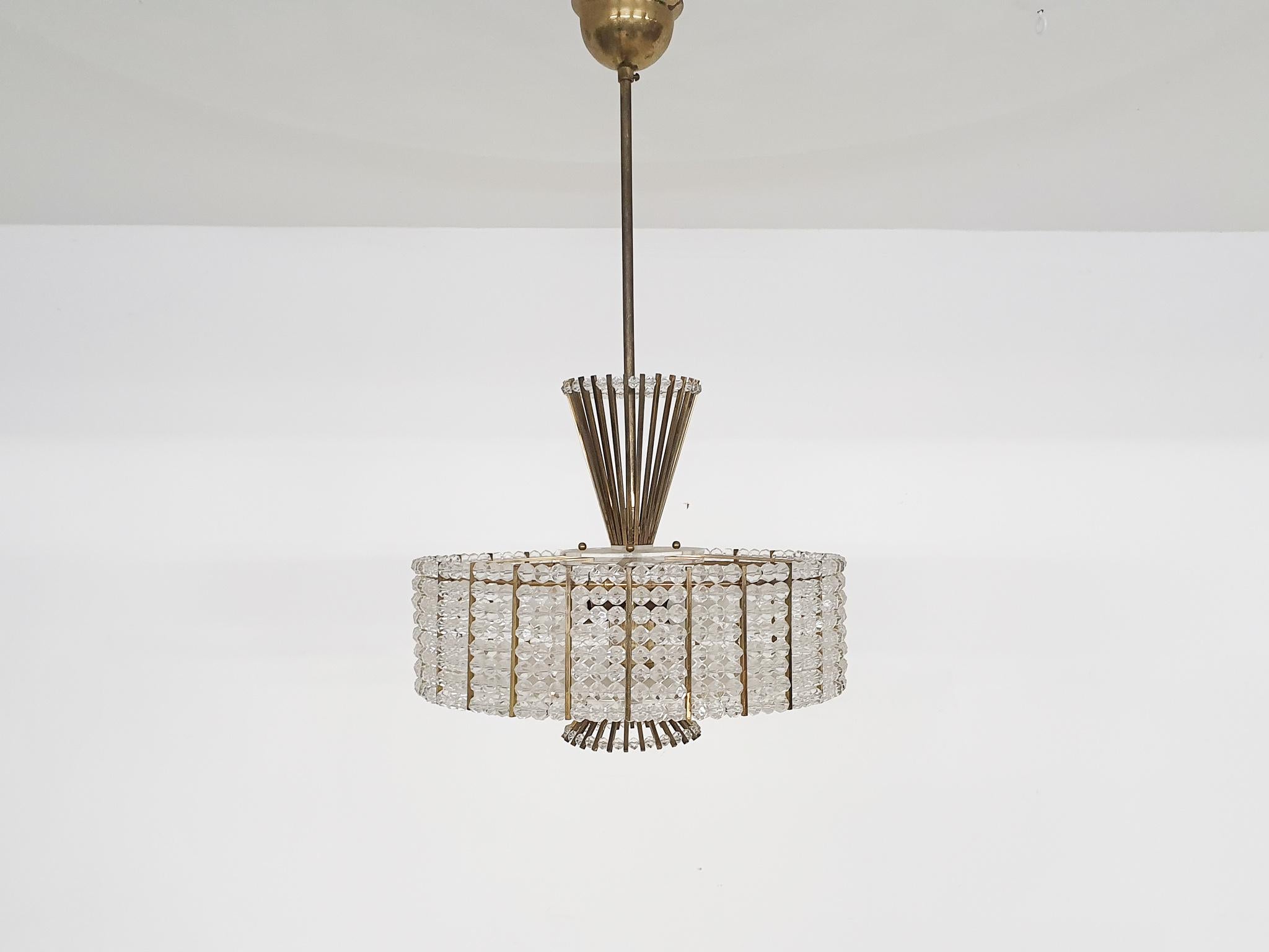Brass and glass chandelier by Emil Stejnar for Rupert Nikoll.
With five E14 light bulbs
Stejnar was born in Vienna, Austria in 1939 and trained as a gold and silversmith. After his study of the stars and the Occult in Sweden he went back to Vienna