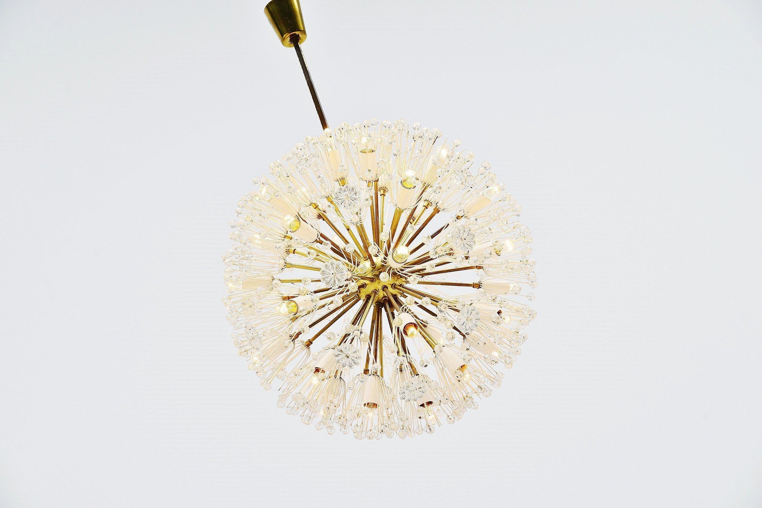 Stunning large chandelier designed by Emil Stejnar and manufactured by Rupert Nikoll, Austria, 1960. The chandelier has a brass structure and solid Chrystal snowflakes and flower shapes. The lamp gives fantastic light when lit and uses several E14