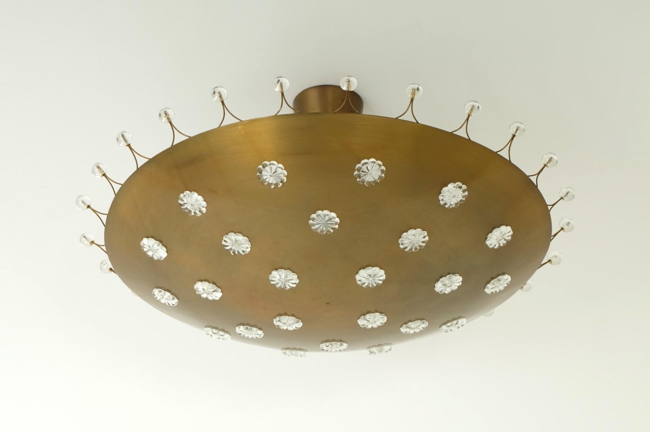 Beautiful ceiling light designed by Emil Stejnar and executed by Rupert Nikoll, Austria in the 1950s.

The lamp in a rare brass version with round glass flower applications and glass beads has a very luxurious look and sparkles particularly