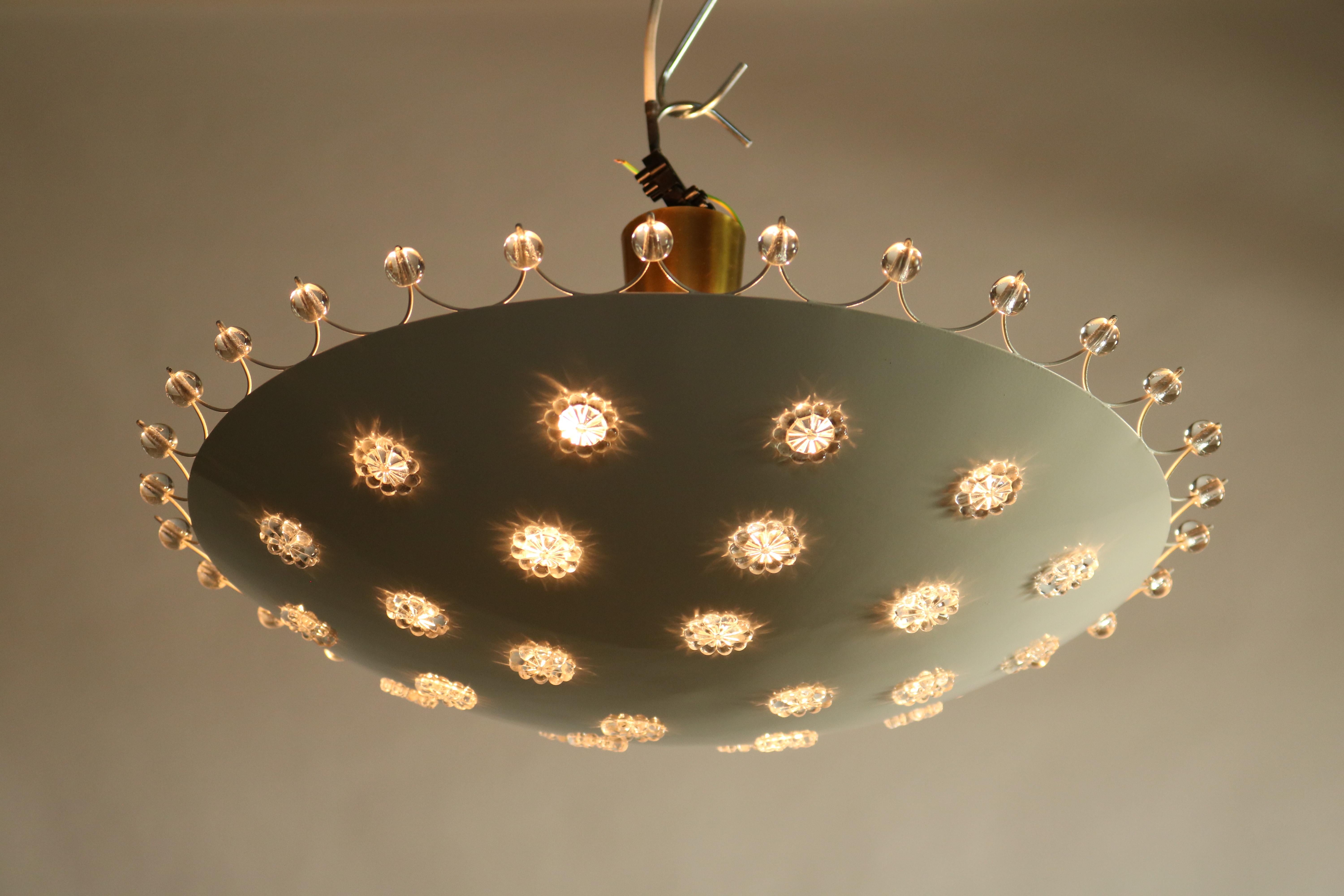 1950s ceiling fixture light suspended on a short rod with a white lacquered sheet steel bowl in which the pearly stars were taken. 
Surrounded by glass beads, this lamp makes an exciting effect light design object.

Measures:

Total height from