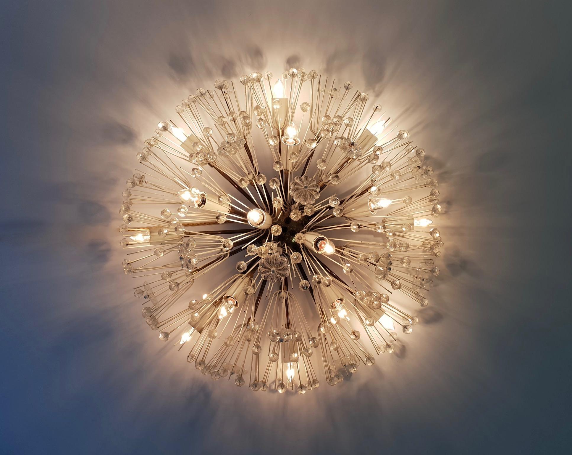 Emil Stejnar flush mount Sputnik chandelier dating to circa 1950s. Designed with a brass body and arms, white enamel sockets, bursts of faceted beads and sprays of glass rosettes. Wear appropriate to age and use, in good condition.
Measures: