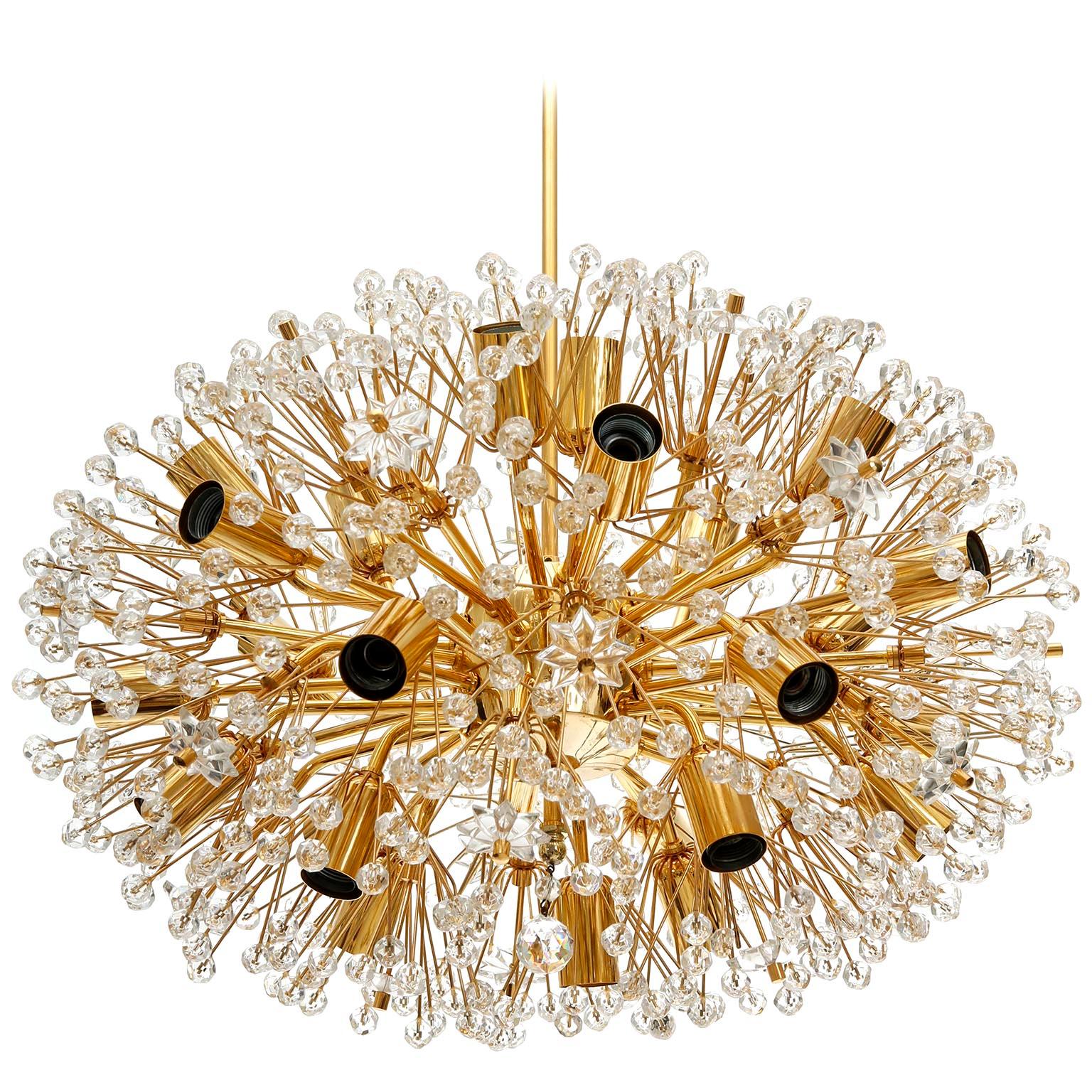 A large and oval shaped Sputnik chandelier designed by Emil Stejnar and manufactured in midcentury, circa 1970.
This beautiful light fixture is made of a 24-carat gold-plated brass frame which is decorated with cut glass in the form of beads and