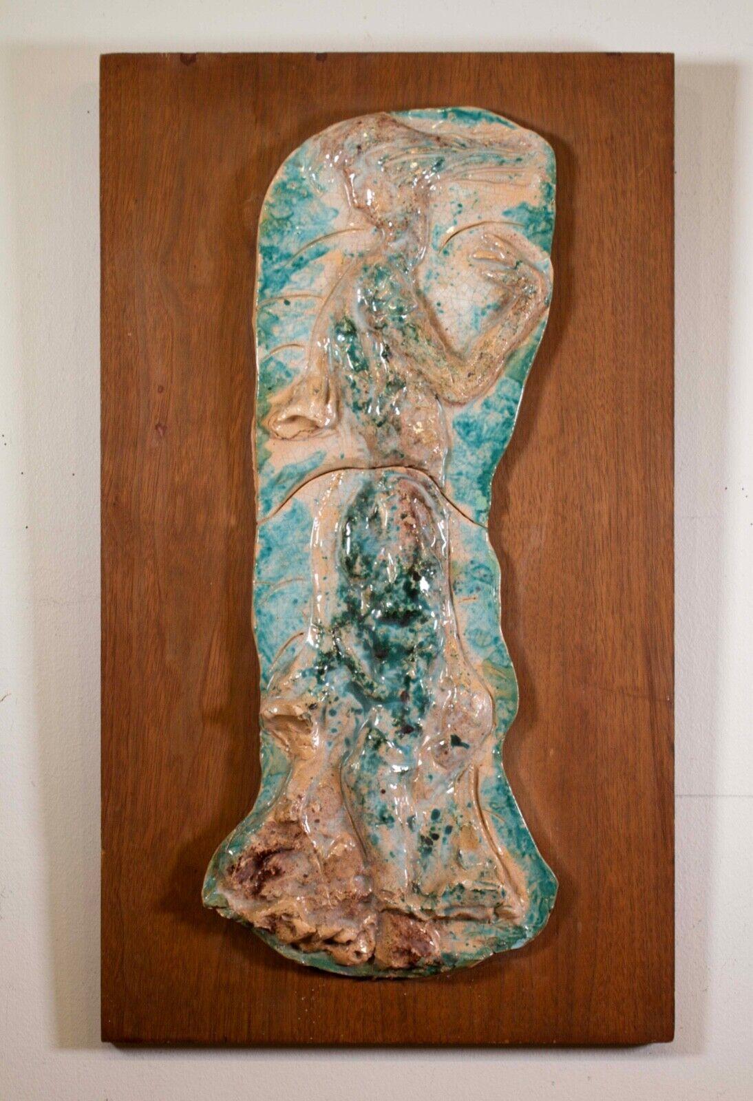 A unique modernist painted ceramic relief sculpture on board by Michigan artist Emil Weddige. A biomorphic abstract shaped ceramic and within emerges an elegant female form. Circa 1960s. Emil Weddige (1907-2001) was a painter, designer, and