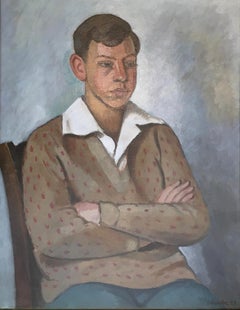 Young man sitting white collar and polka dot sweater
