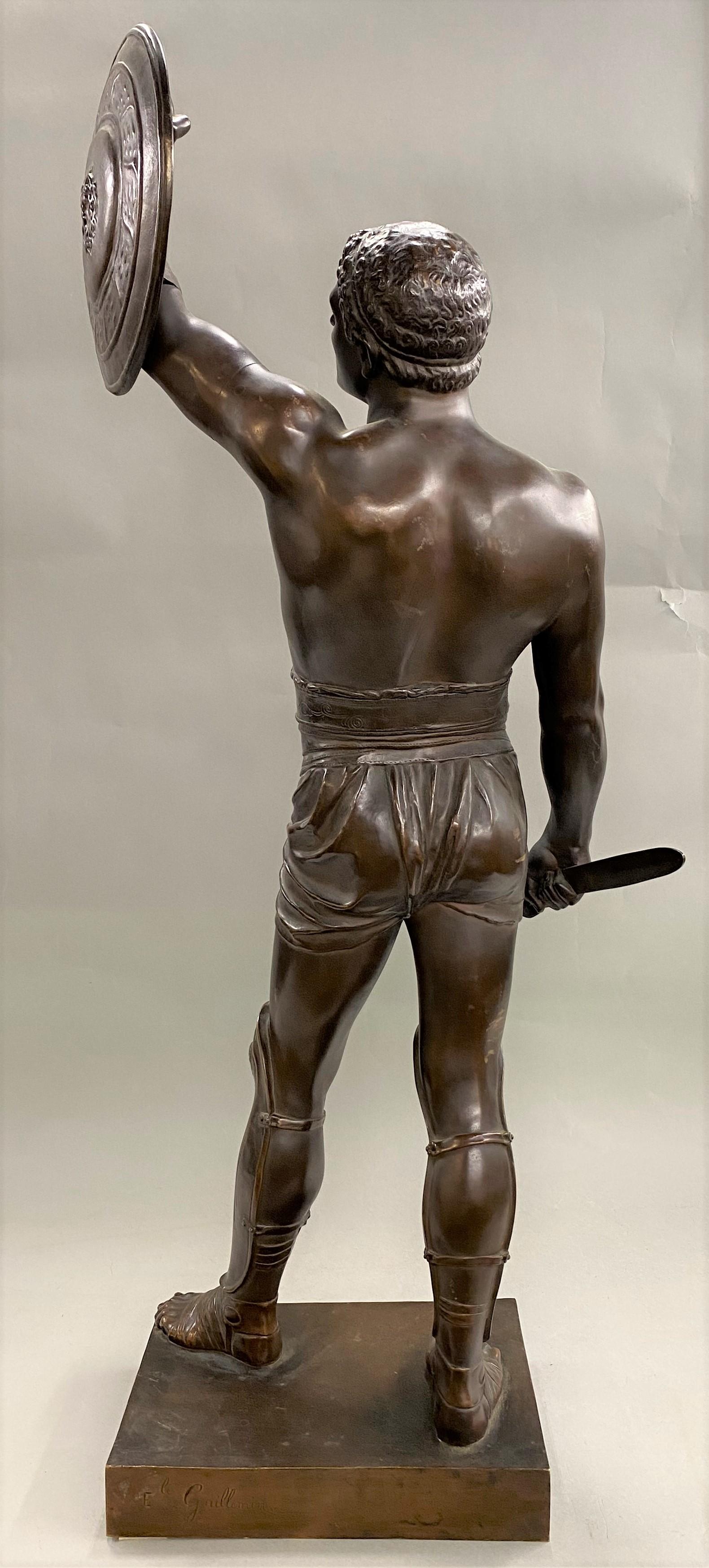 A fine patinated bronze figure of Roman gladiator Retiarius by French sculptor Emile Coriolan Hippolyte Guillemin (1841-1907). Guillemin was born in Paris, France, son of the painter Emile Marie Auguste Guillemin and studied under him and under