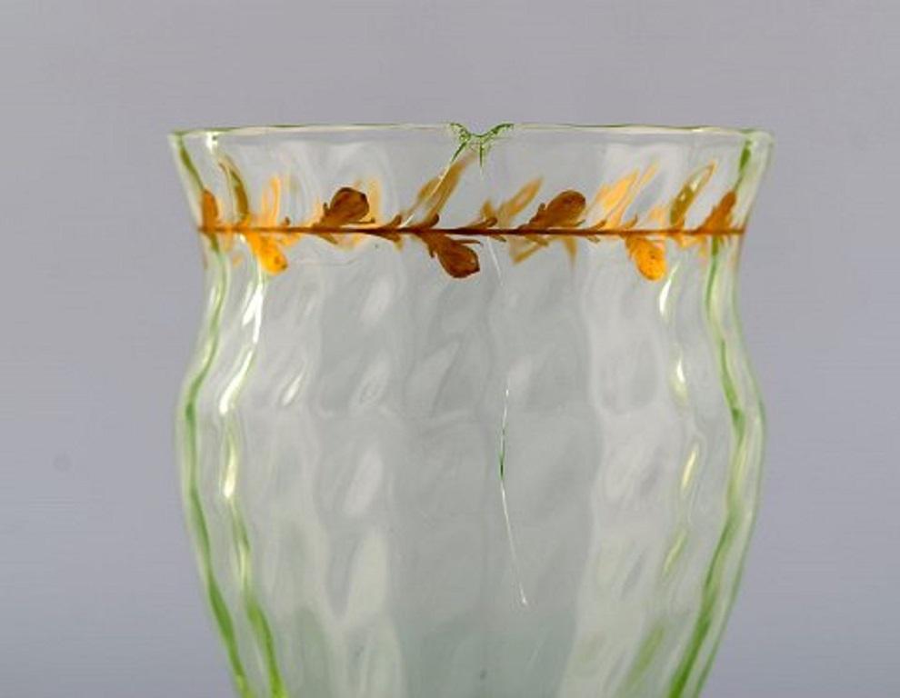 Emile Gallé (1846-1904). Early and rare wine glass in mouth-blown light green art glass with hand painted gold decorations in the form of leaves. Museum quality, 1870s-1880s.
Measures: 16.5 x 7 cm.
With crack and chip.
Signed.