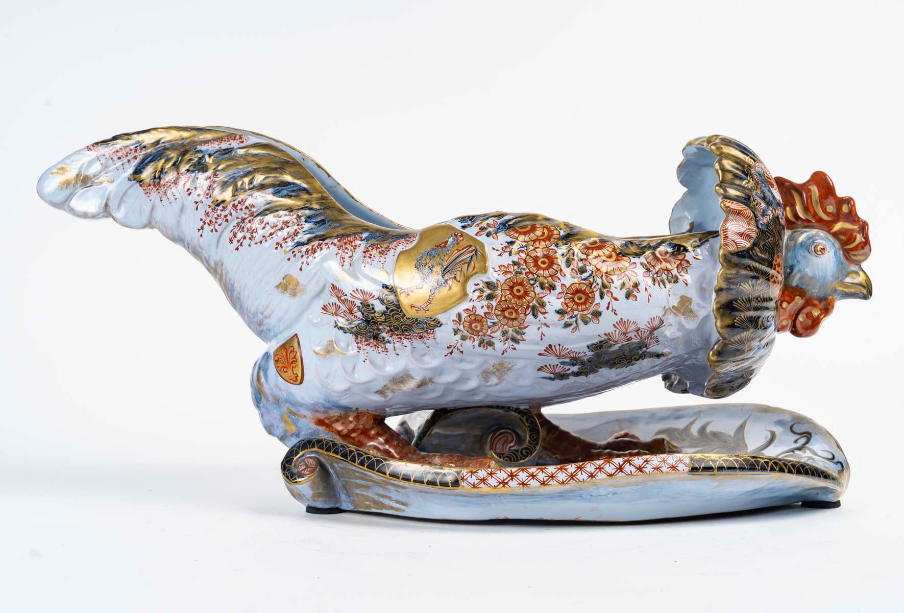 Émile Gallé (1846-1904)
Very Rare Coq/Rooster Jardiniere

An earthenware jardiniere designed as a rooster
Faience simulating Japanese Imari Polychromed porcelain with blue, red and gold highlights hand-painted design on a milky background, 
The