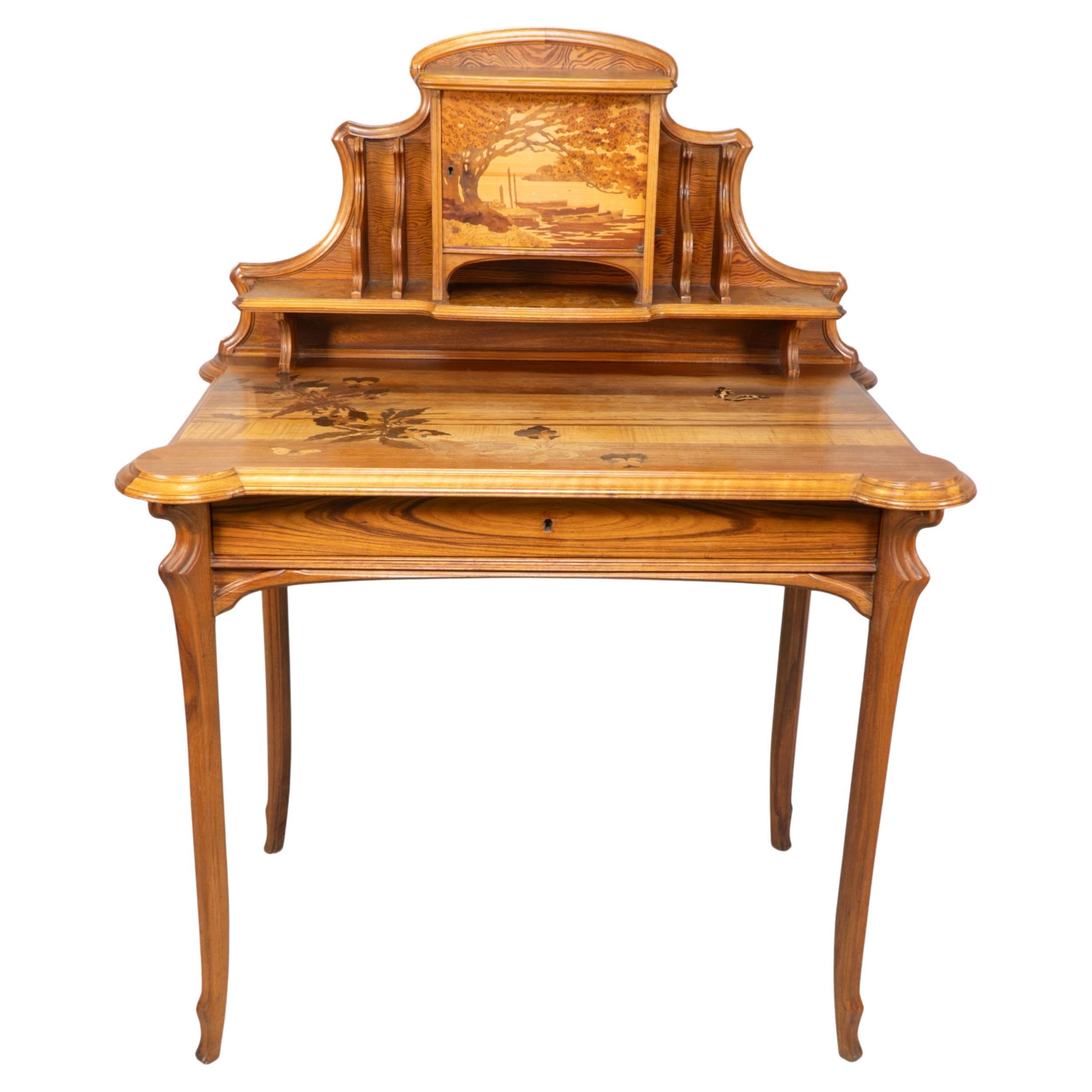 Emile Galle. An Art Nouveau Walnut writing desk with exceptional inlaid scenery